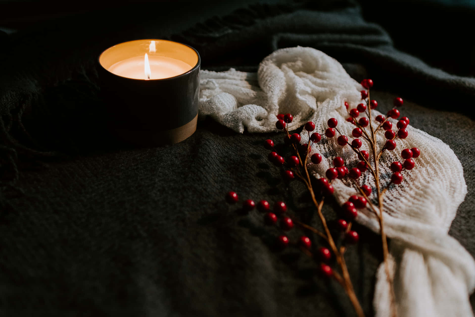 A Candle And Berries On A Bed Background