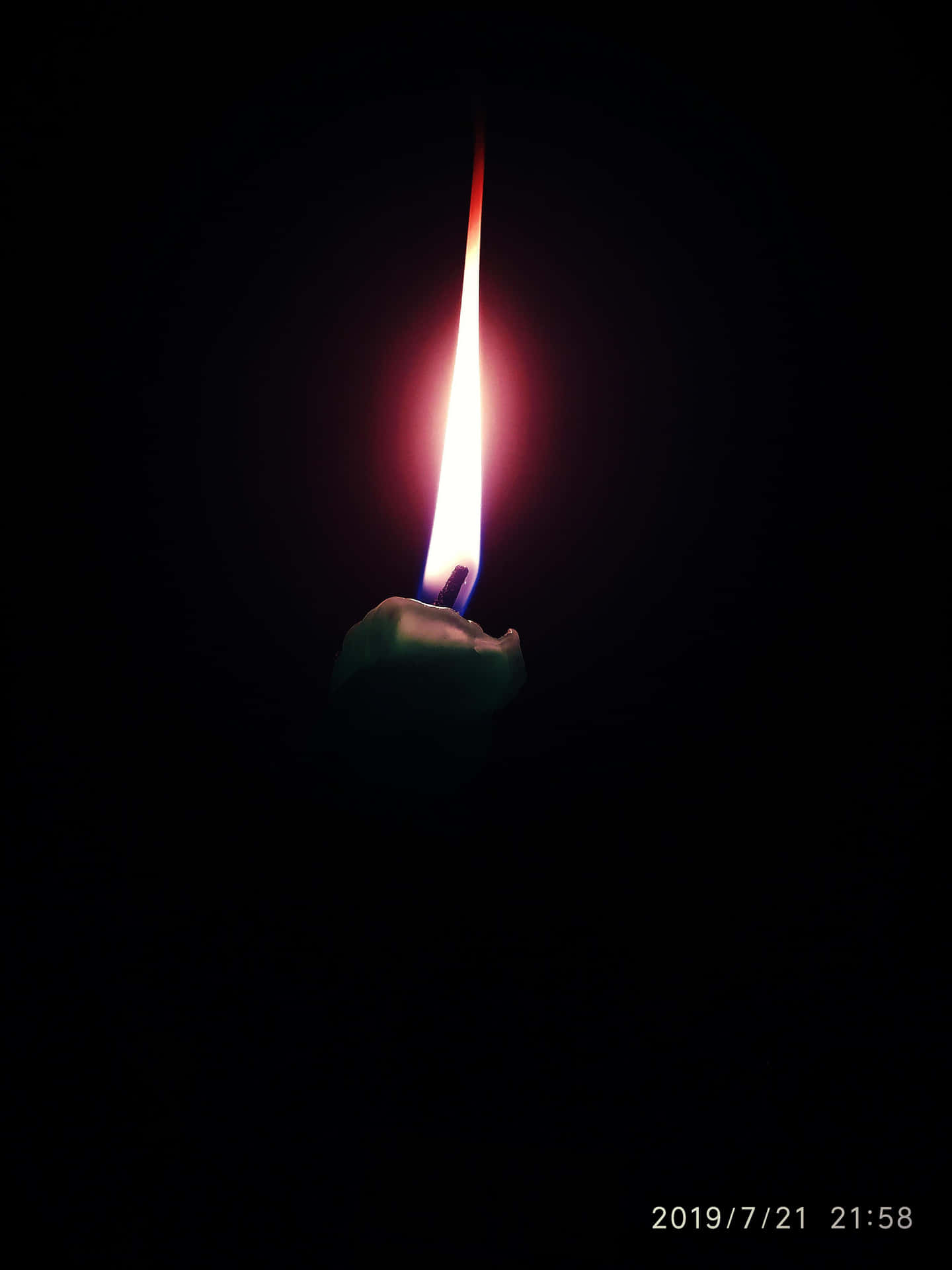 A Candle Lit In The Dark With A Black Background Background