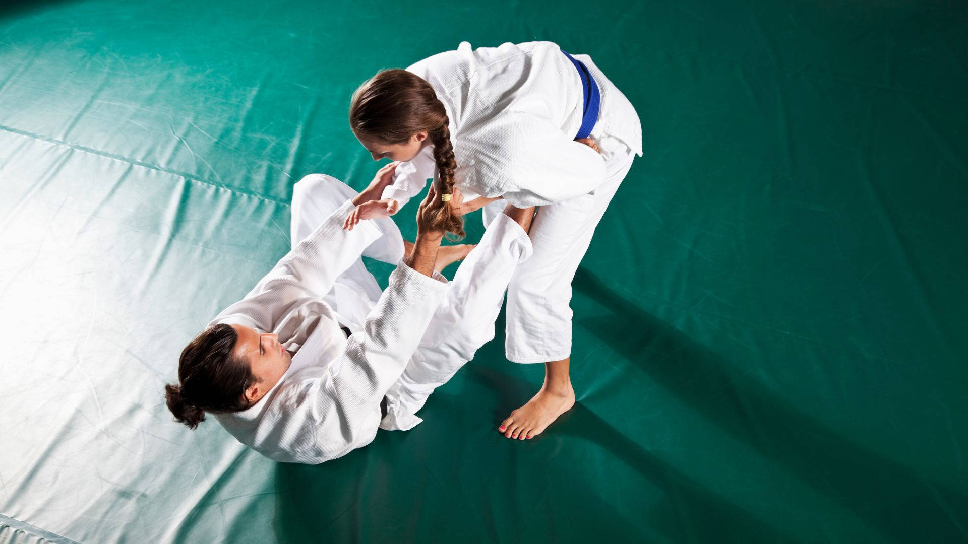 A Captivating Demonstration Of Brazilian Jiu-jitsu Prowess By Both Men And Women Contenders. Background