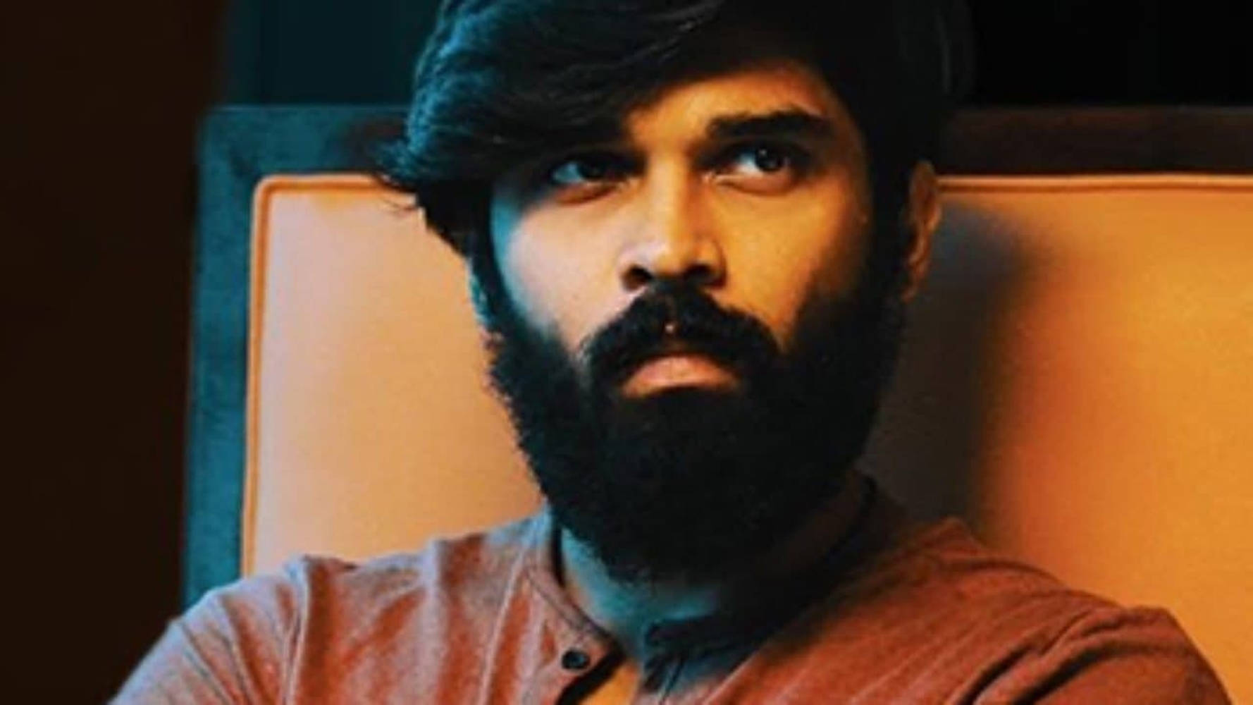 A Captivating Still Of Adithya Varma Sporting His Signature Beard