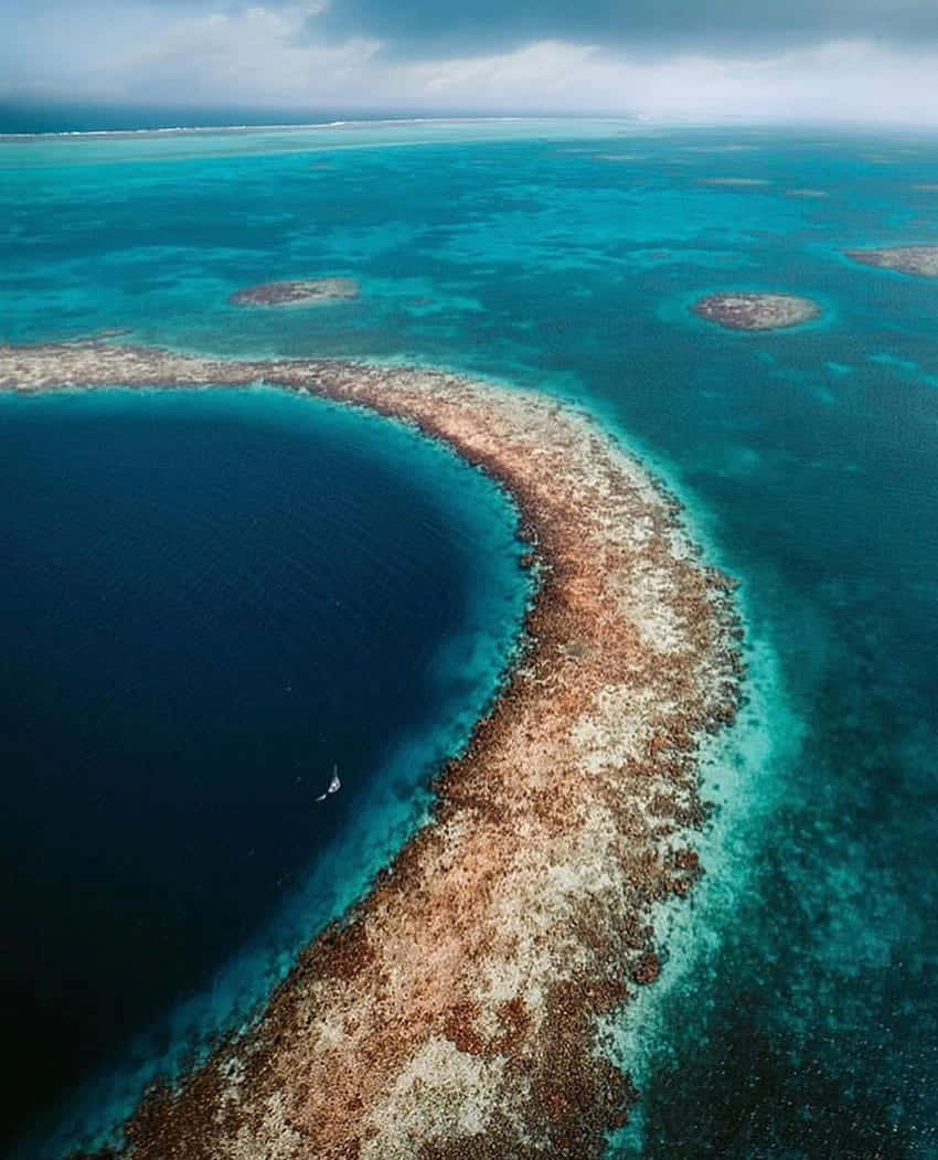 A Captivating View Of The Great Blue Hole, An Underwater Sinkhole Off The Coast Of Belize. Background