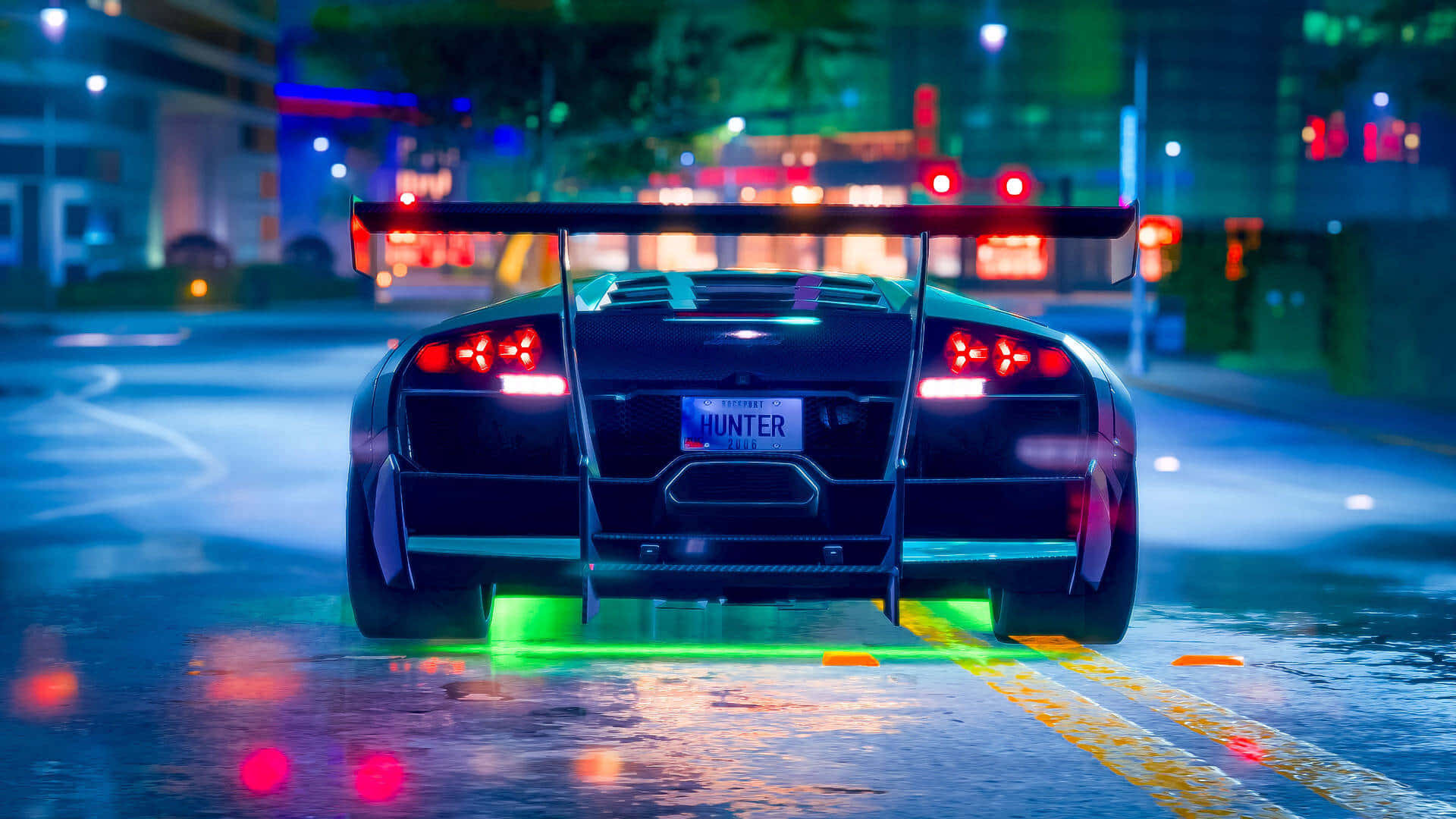 A Car Driving Down A Street At Night