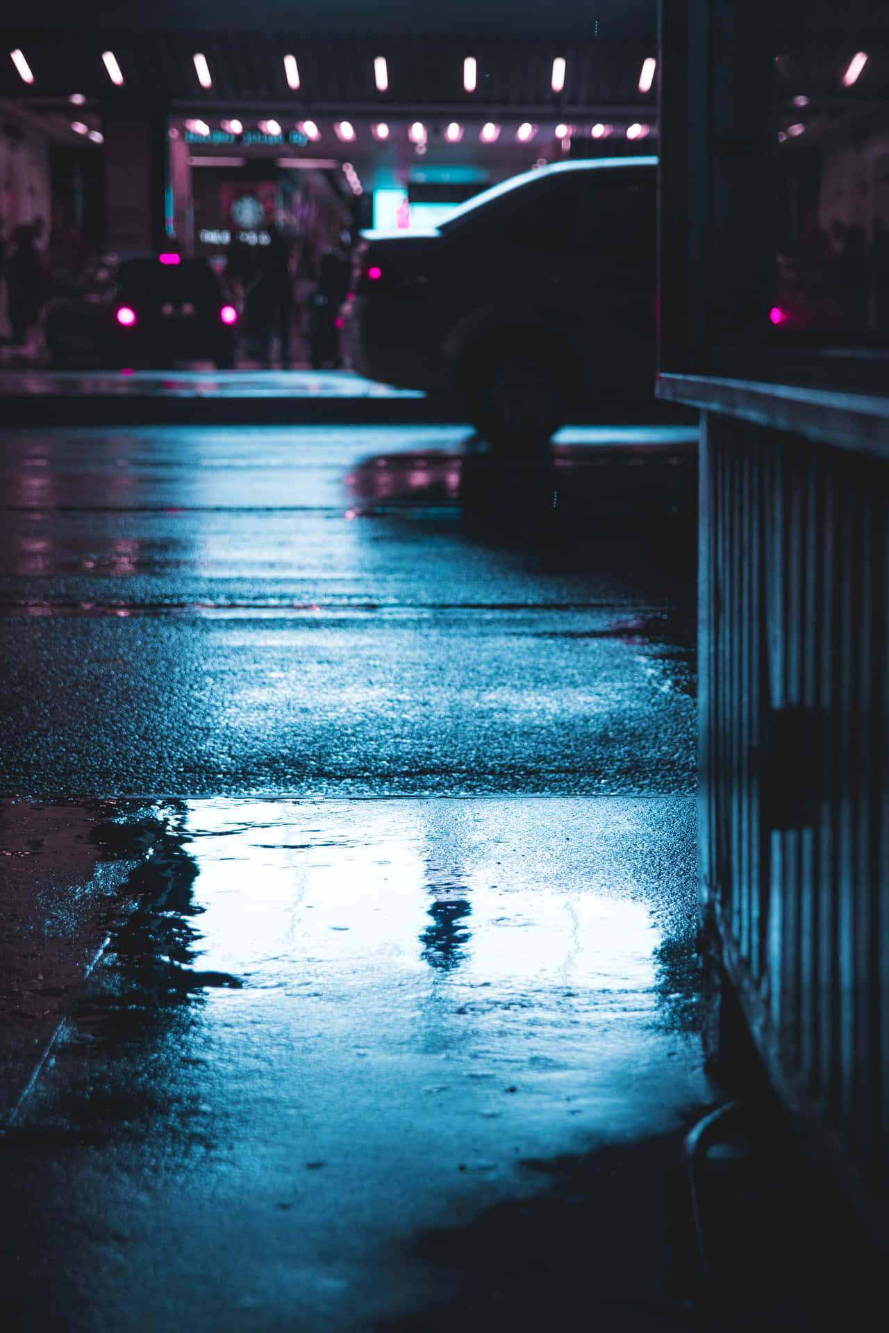 A Car Driving Down A Street At Night