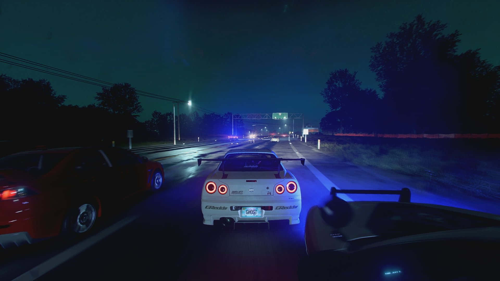 A Car Driving Down The Road At Night Background