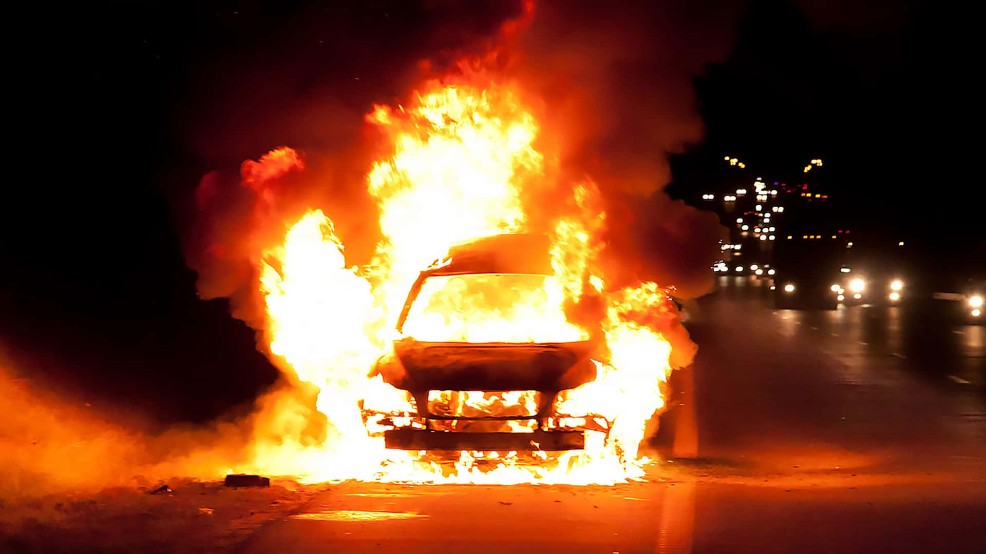 A Car Is On Fire On The Side Of The Road Background