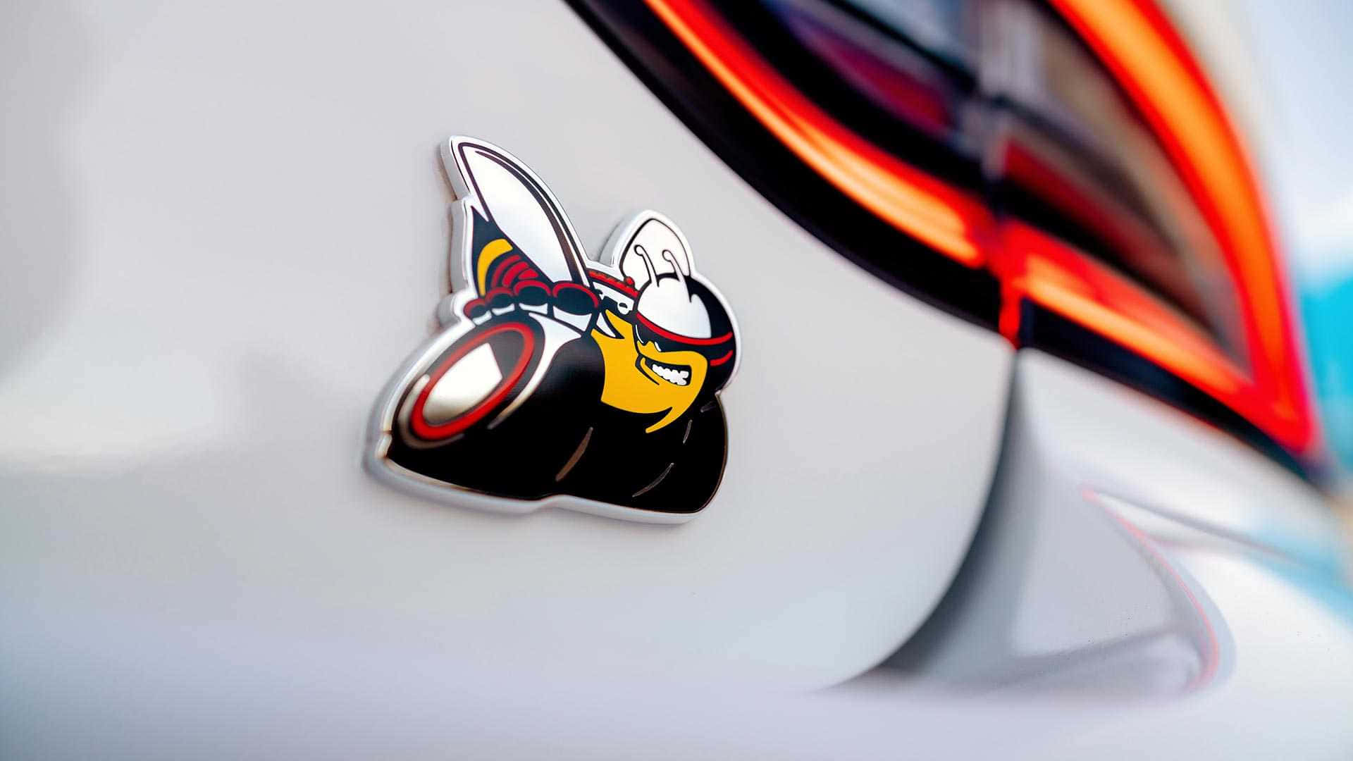 A Car With A Cartoon Character On The Back Of It Background