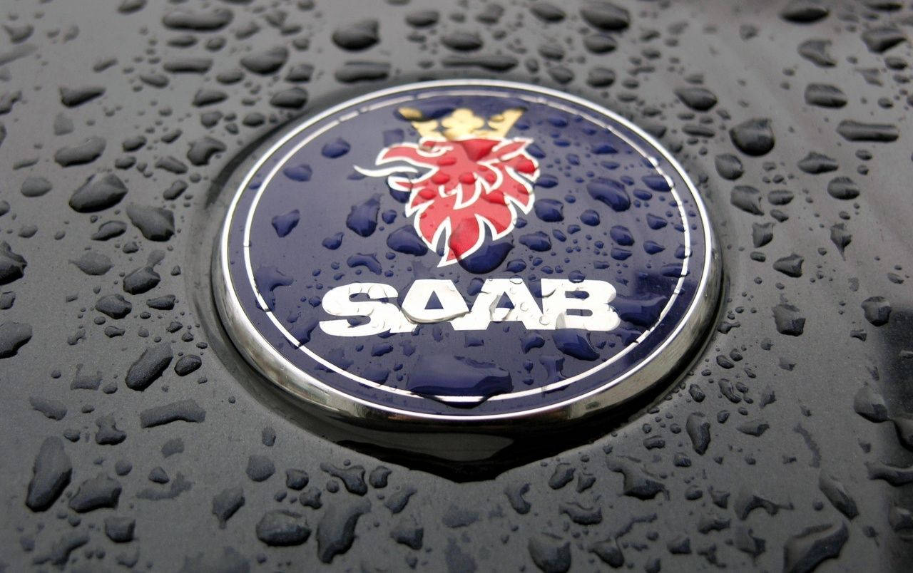 A Car With A Logo Of Soab On The Hood Background