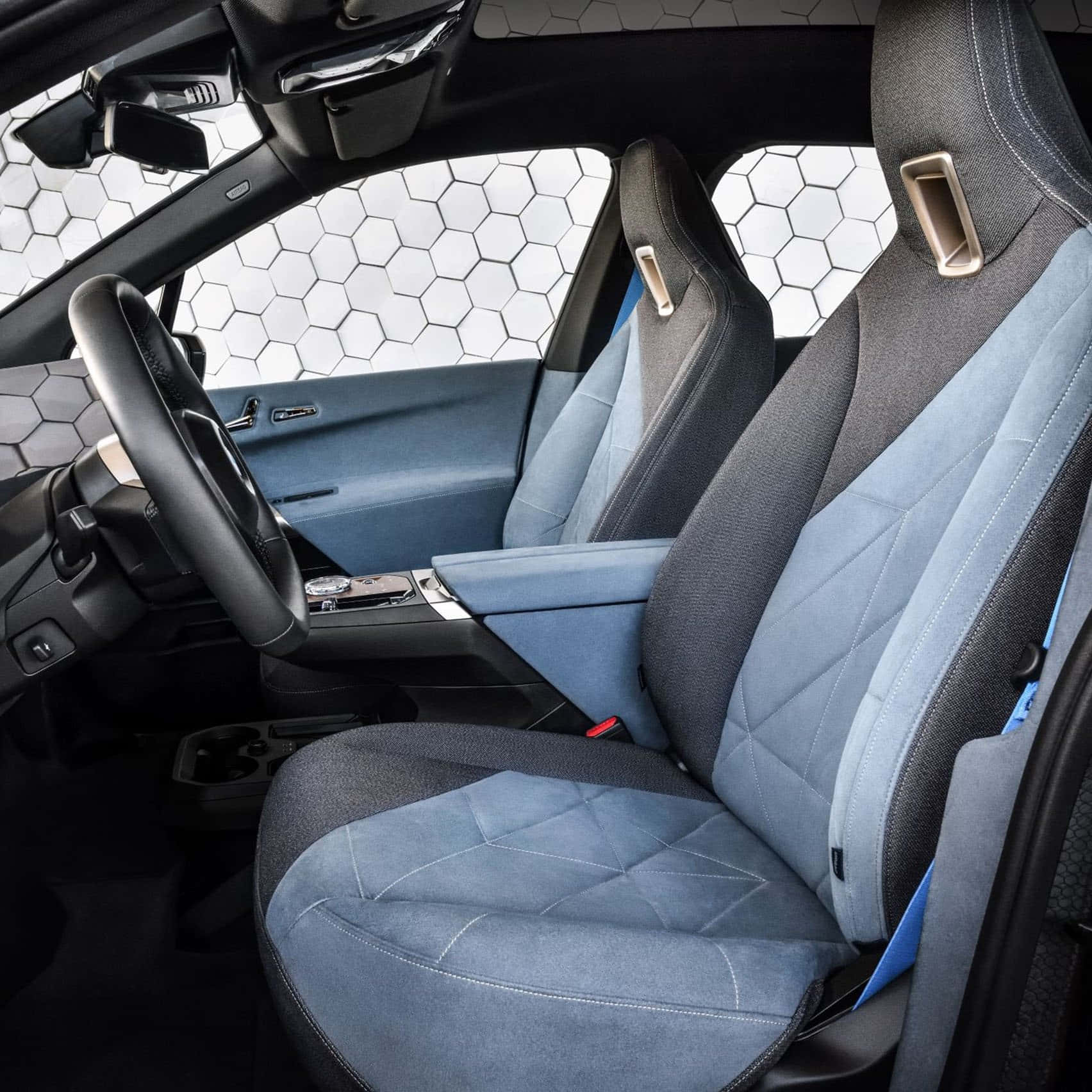 A Car With Blue Leather Seats And A Steering Wheel Background