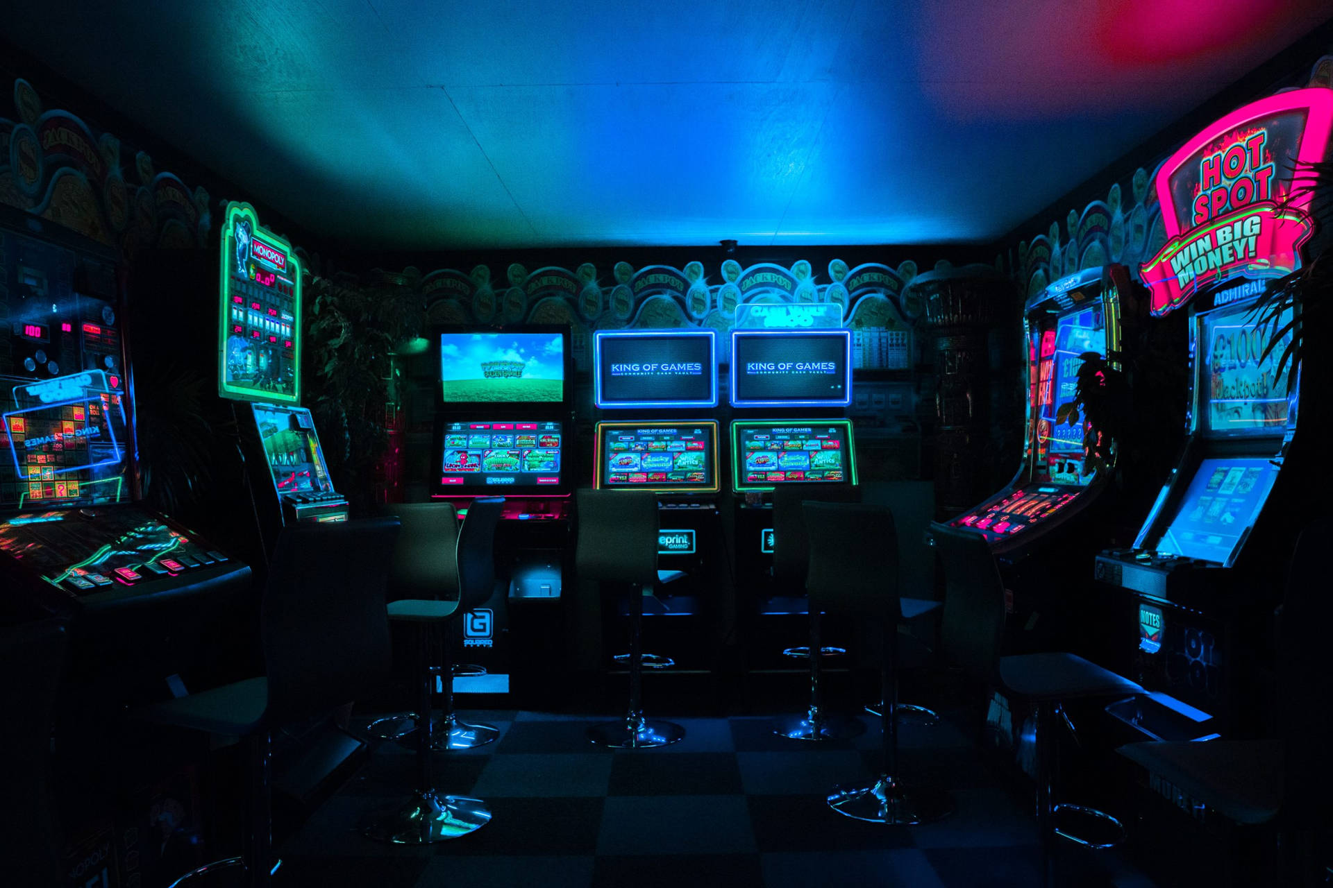 A Casino Room With Many Slot Machines Background