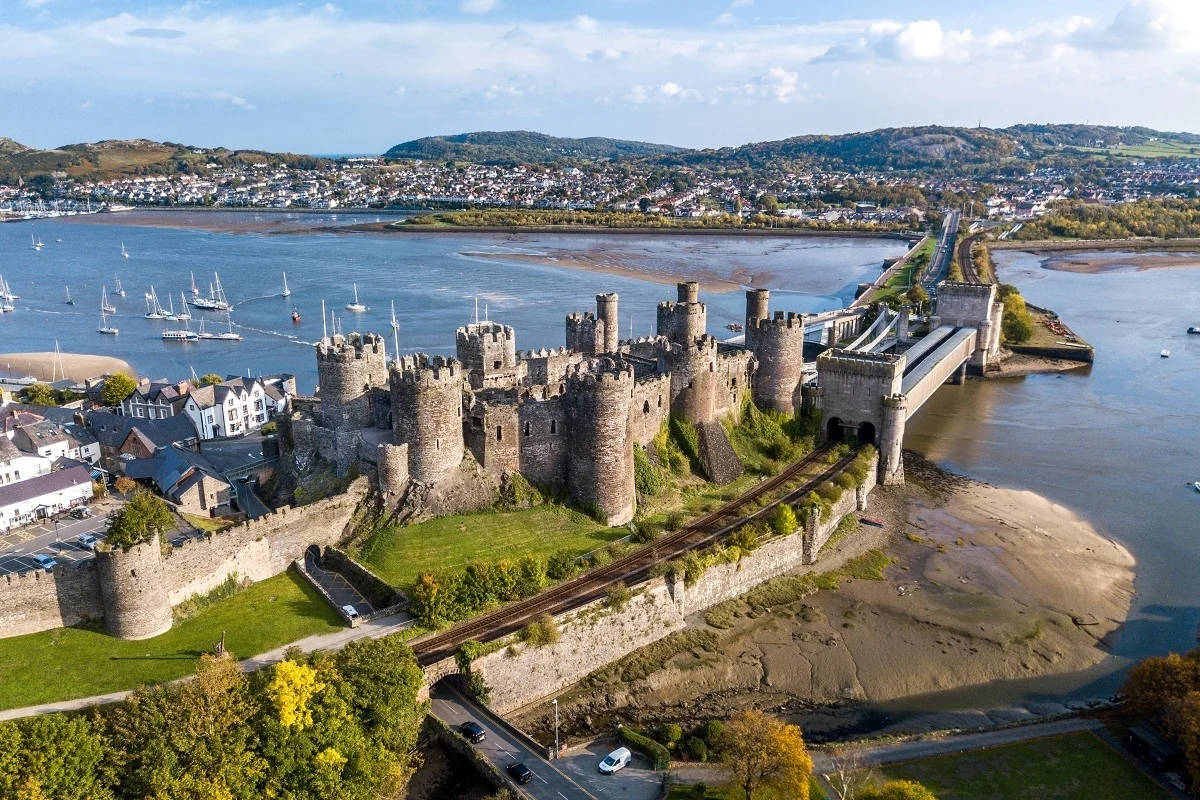 A Castle And A River In Wales Background