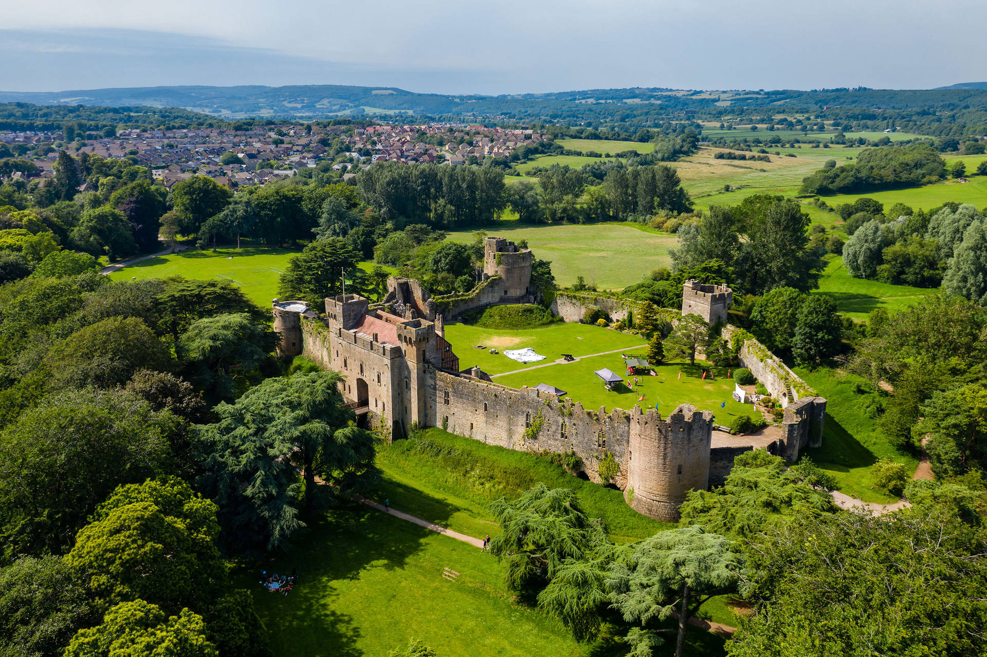 A Castle In The Middle Of A Green Field Background