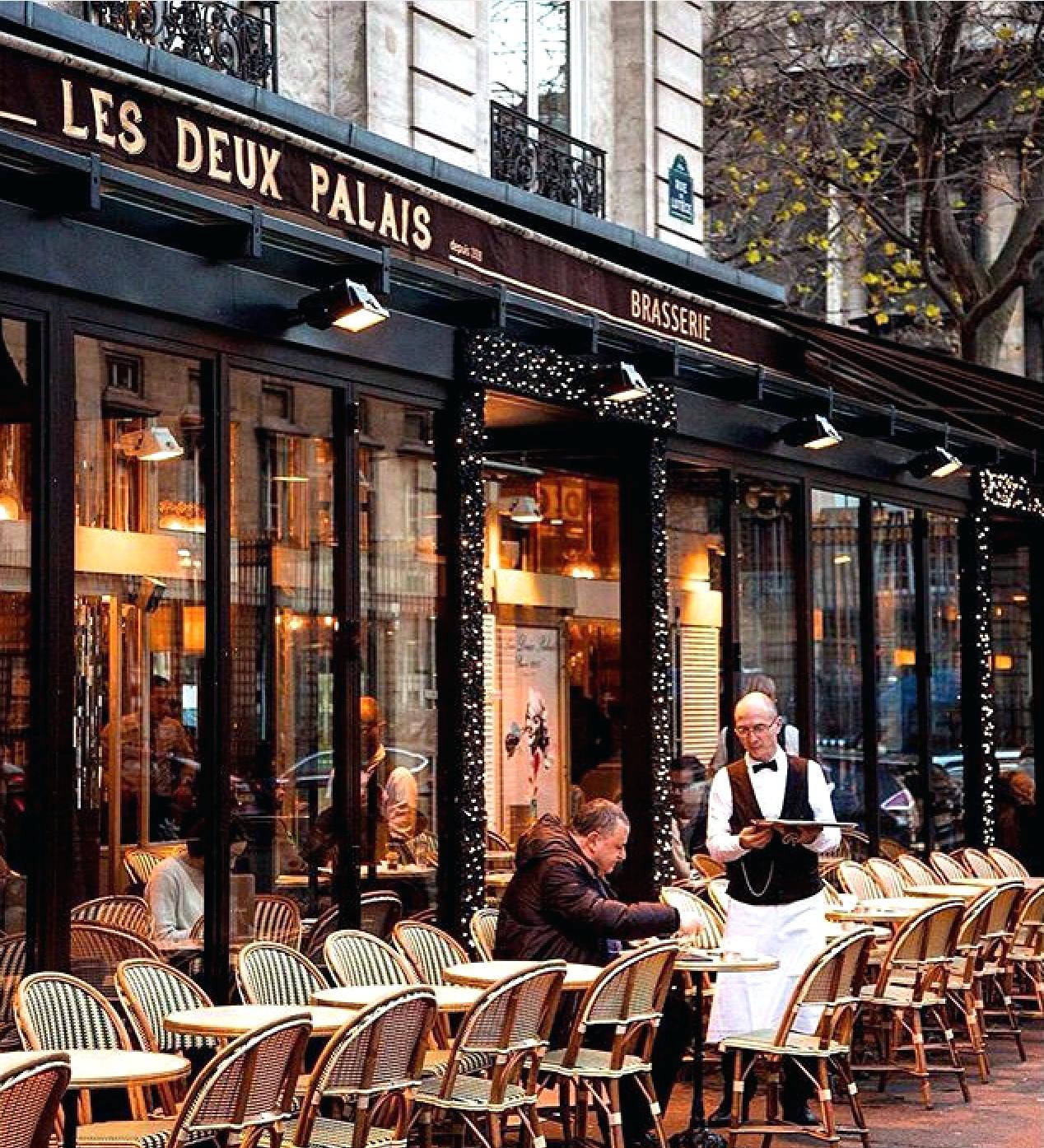 A Charming Parisian Café In The Heart Of Paris Background