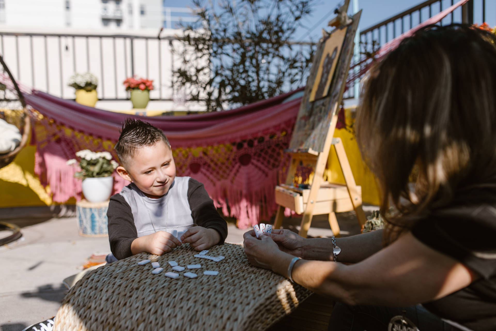 A Child Immersed In A Game Of Dominos