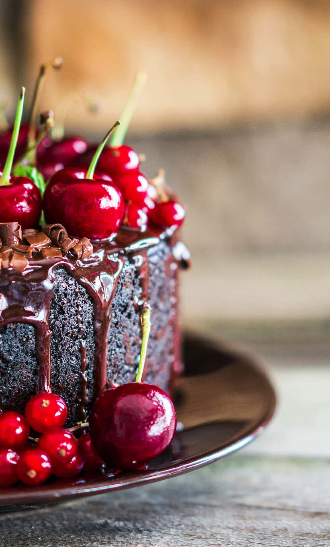 A Chocolate Cake With Cherries On Top Background