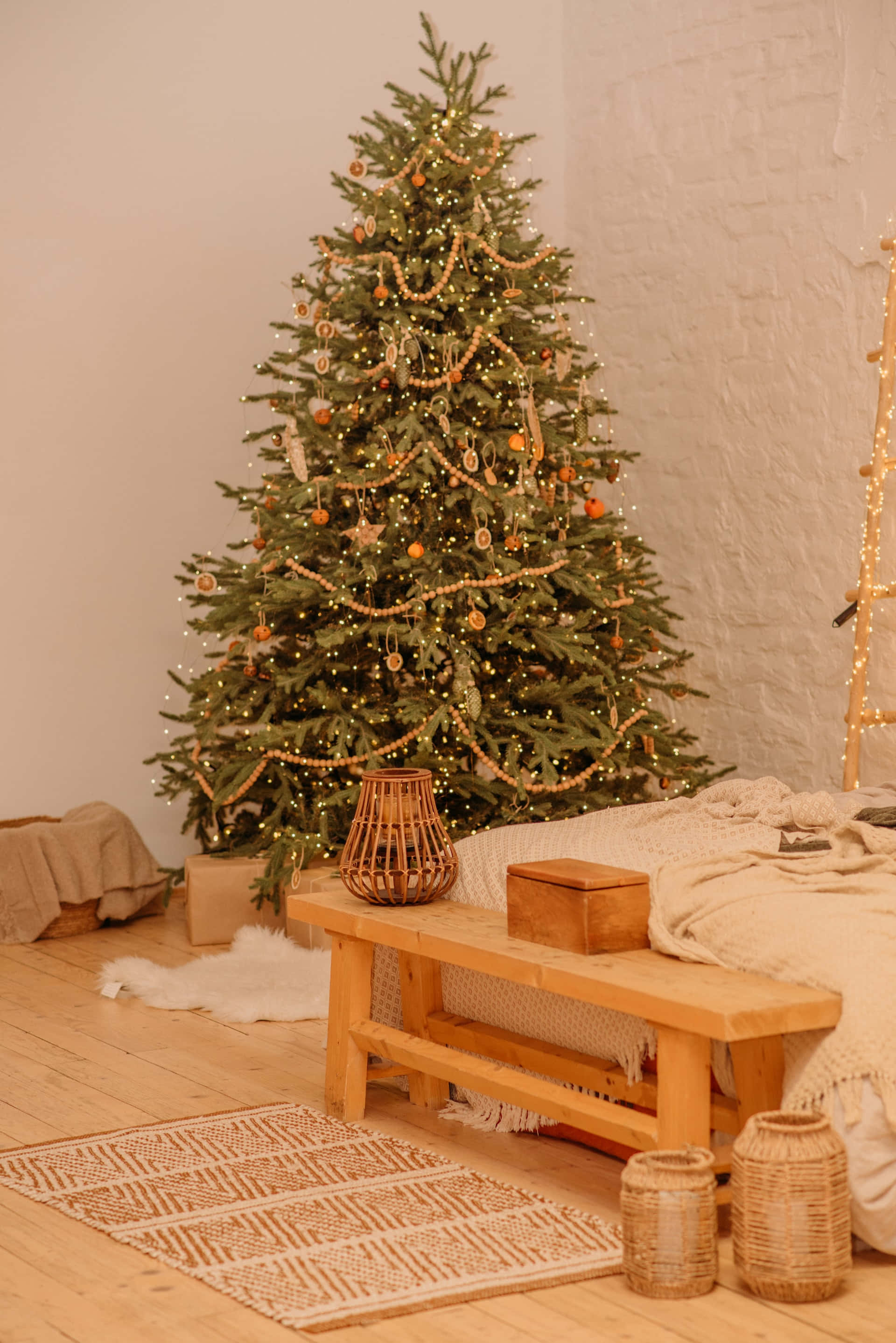 A Christmas Tree In A Room With A Bed And A Ladder Background