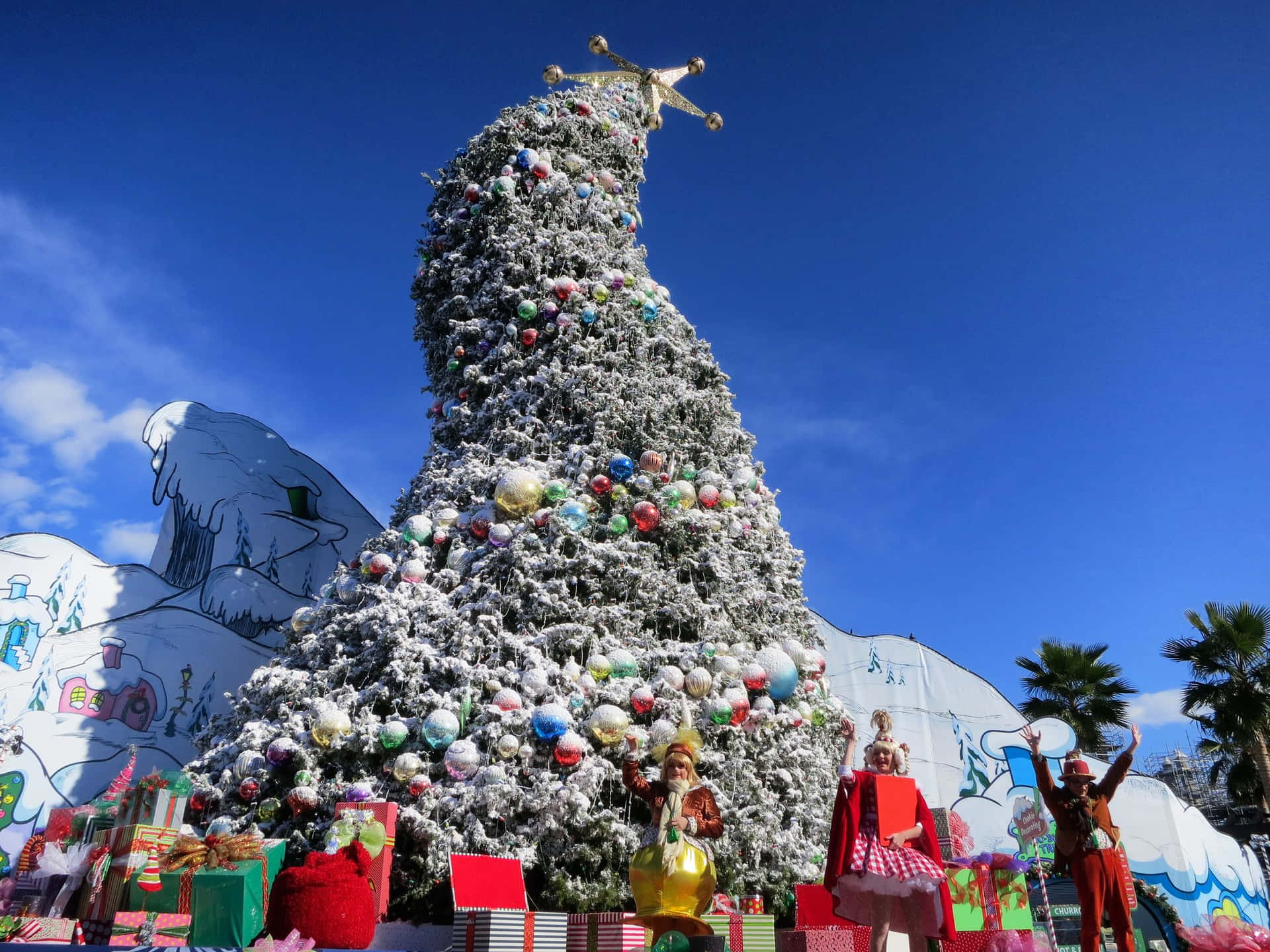 A Christmas Tree With A Large Number Of Presents On It Background