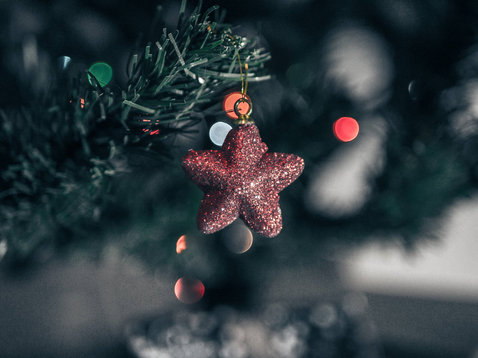 A Christmas Tree With A Star Ornament Hanging From It Background