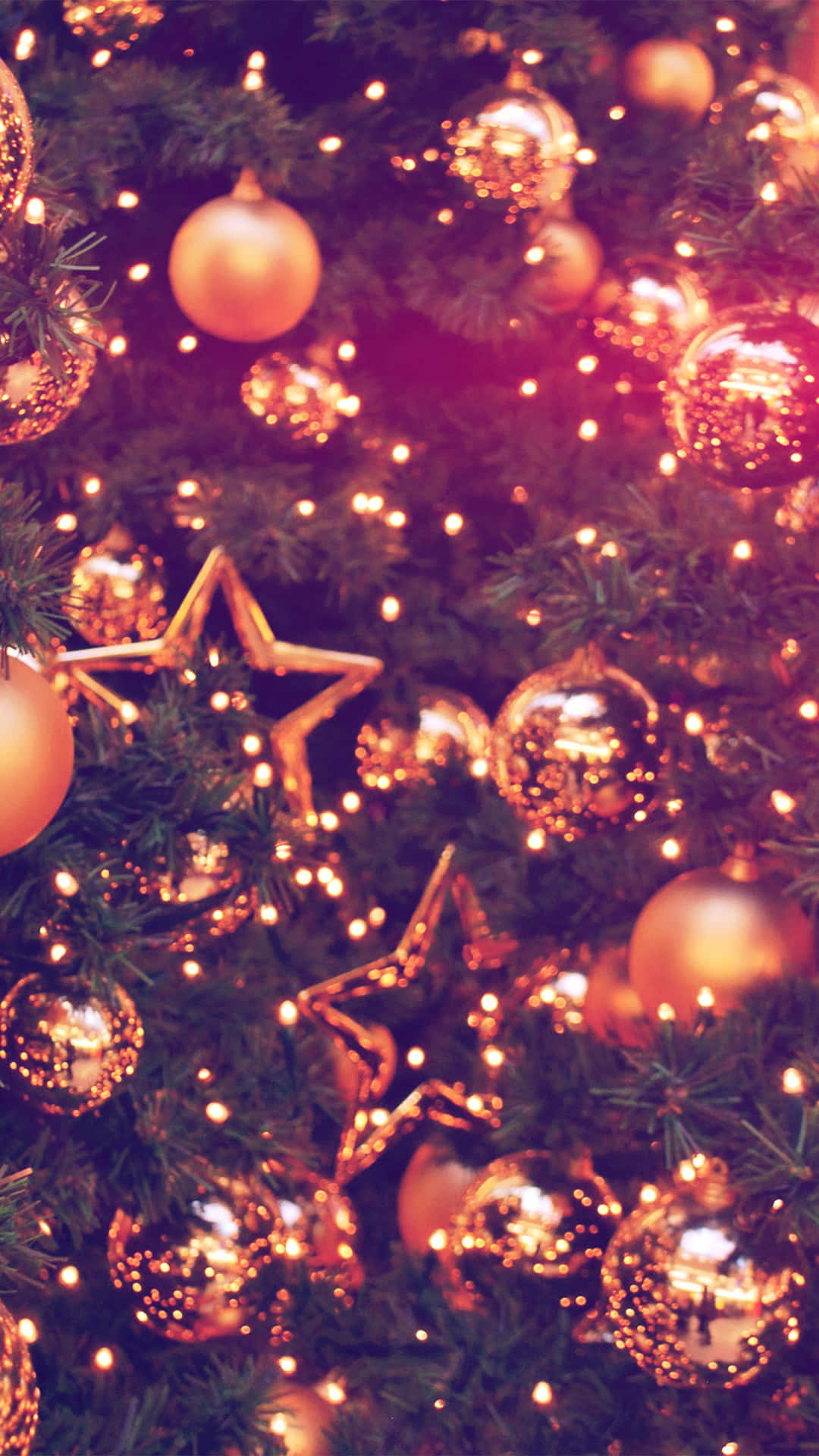 A Christmas Tree With Gold Ornaments And Stars Background