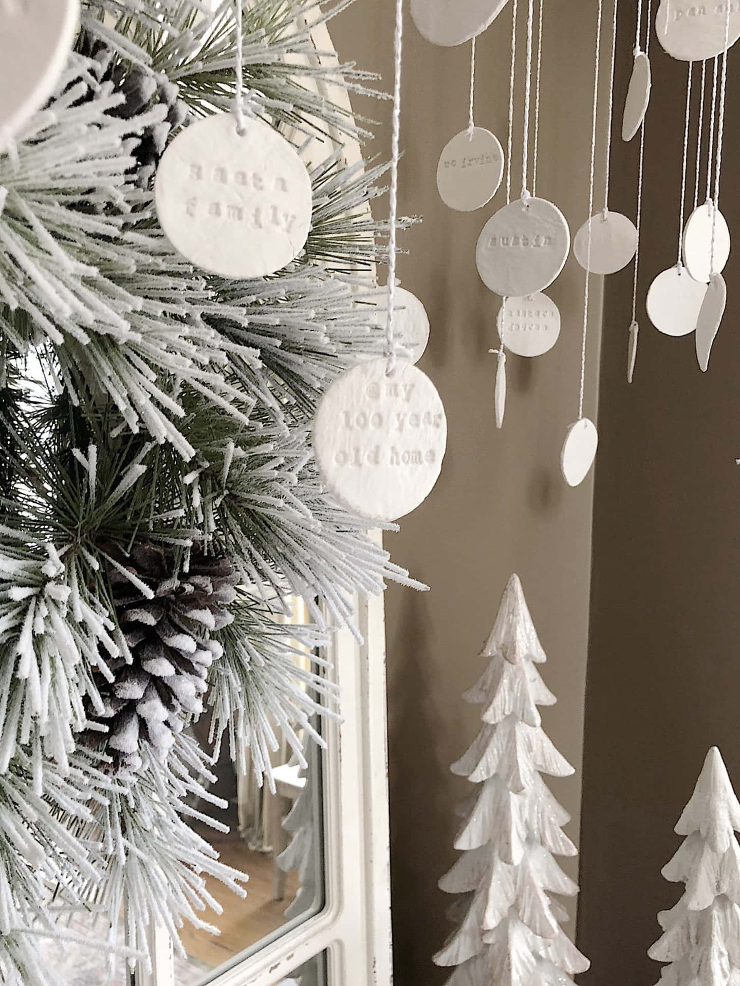 A Christmas Tree With White Decorations Hanging From It Background