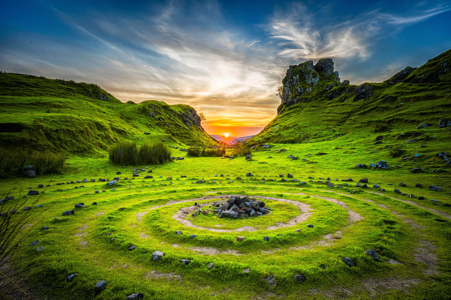 A Circular Grassy Field With Rocks In The Middle