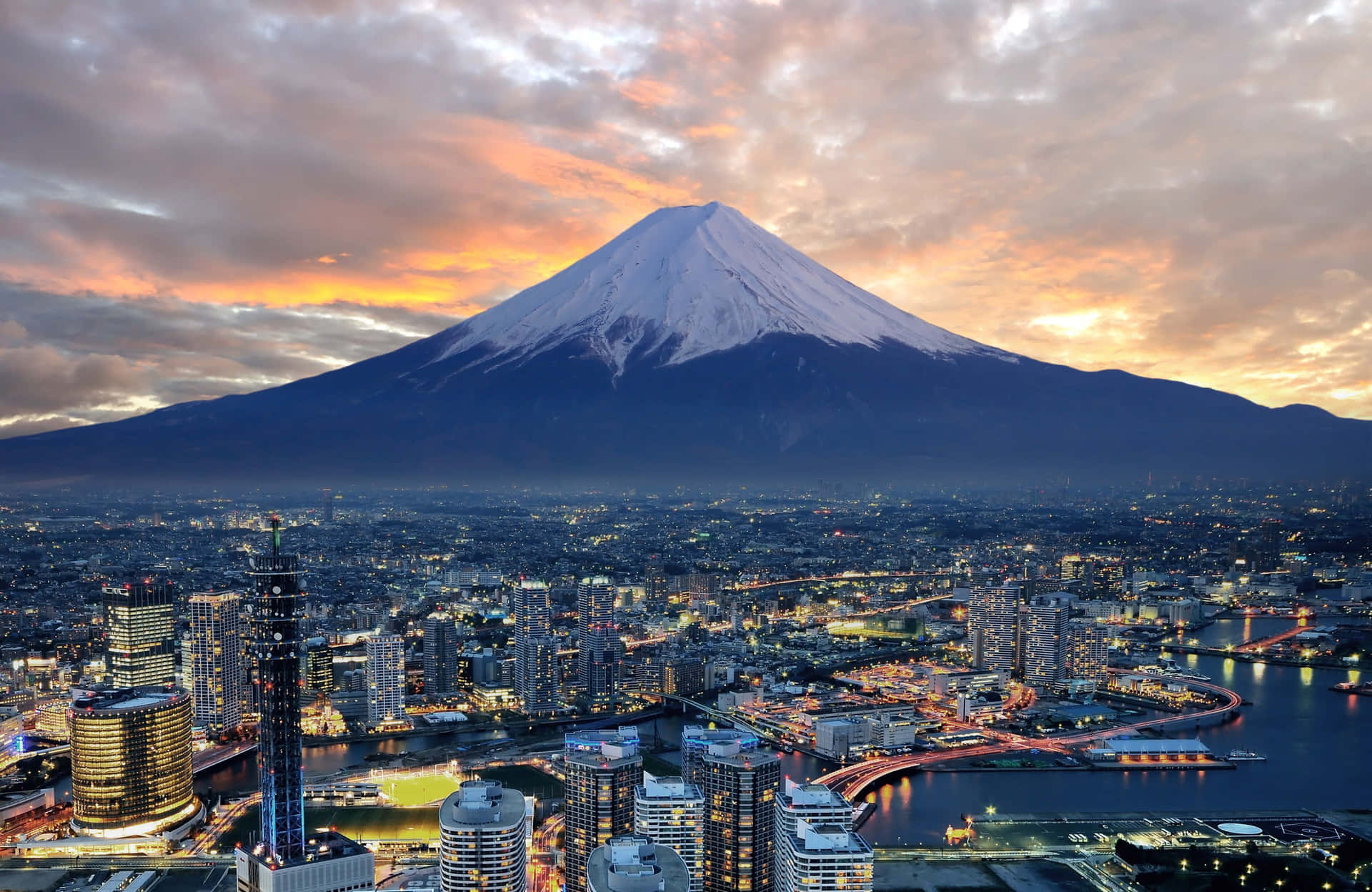 A City And Mountain At Dusk Background