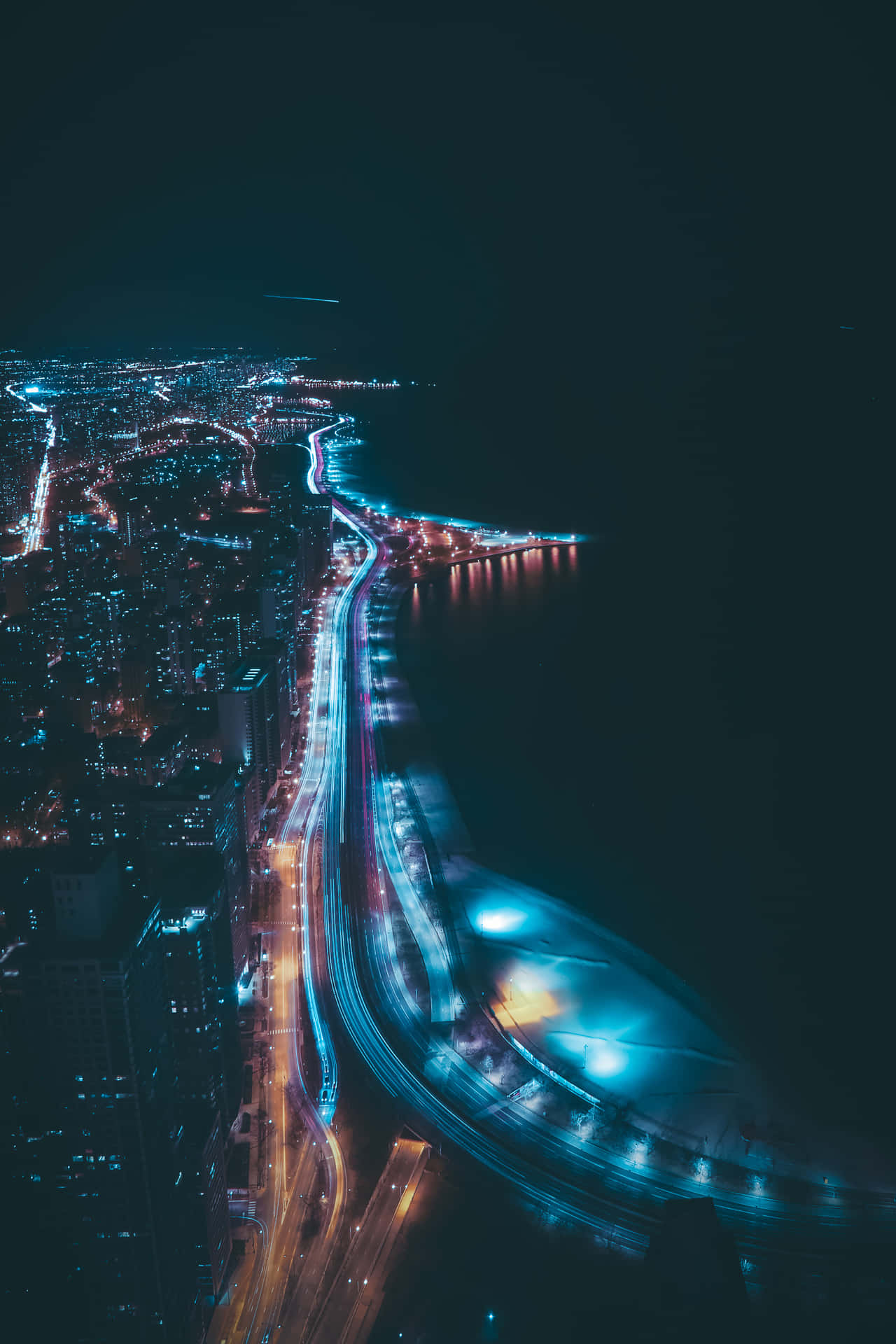 A City At Night With A Blue Sky And Traffic Background