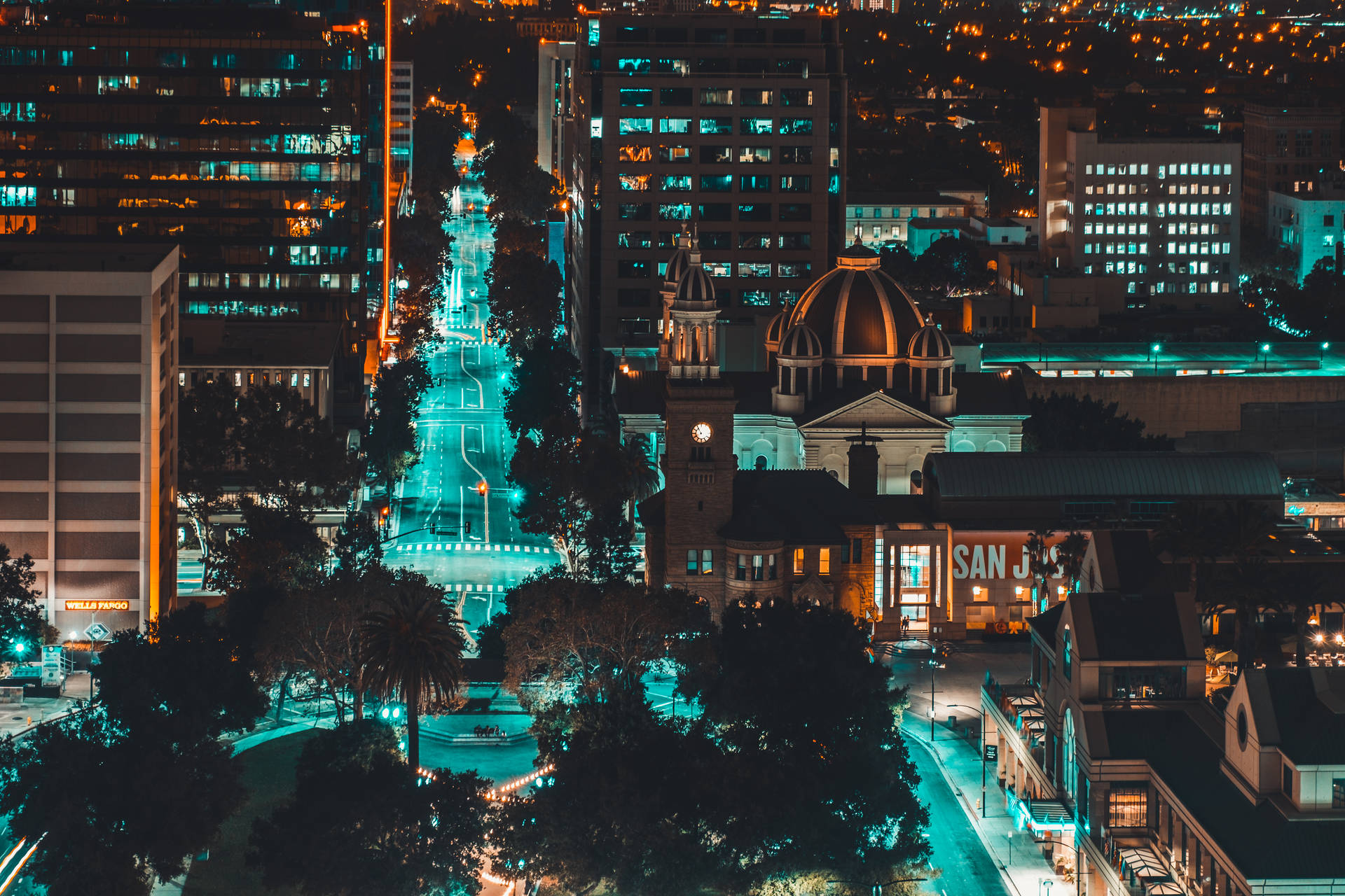 A City At Night With Buildings And Trees Background