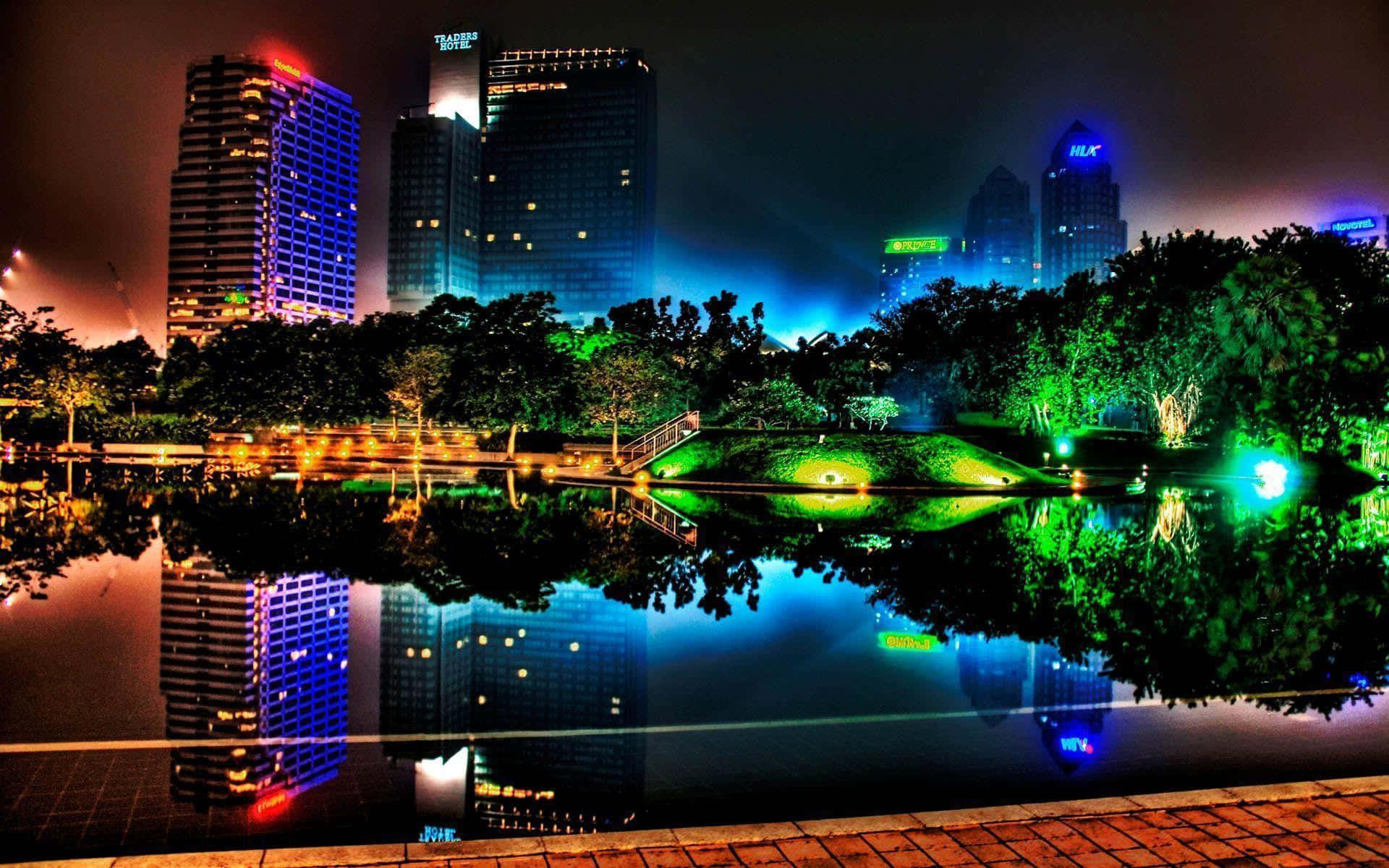 A City At Night With Lights Reflecting In The Water Background
