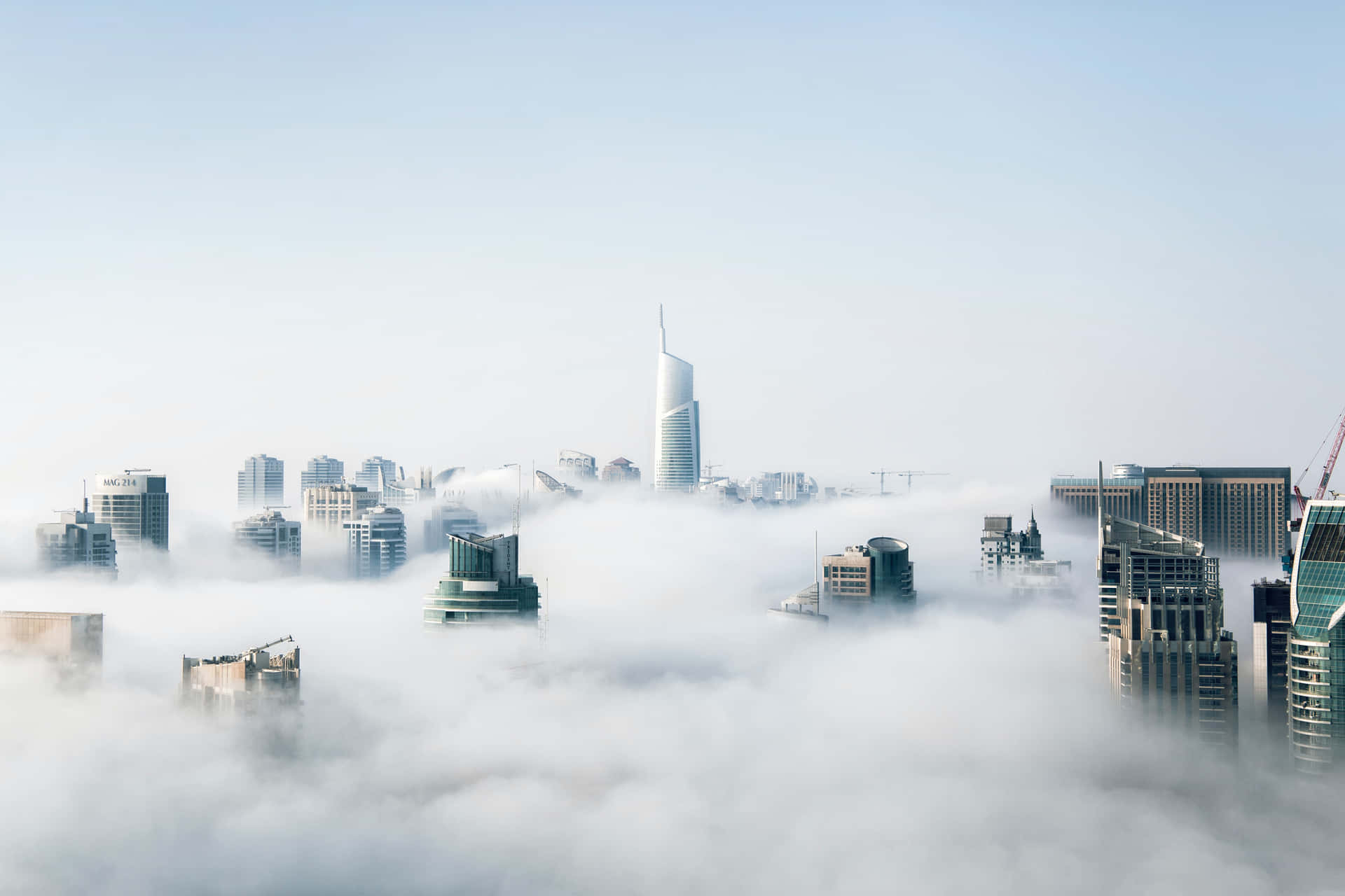 A City Covered In Clouds With Tall Buildings