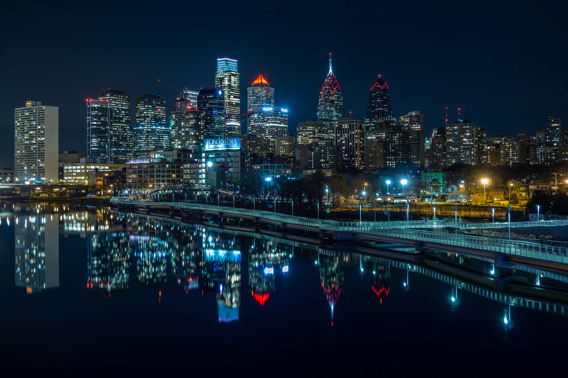 A City Skyline Is Reflected In The Water Background