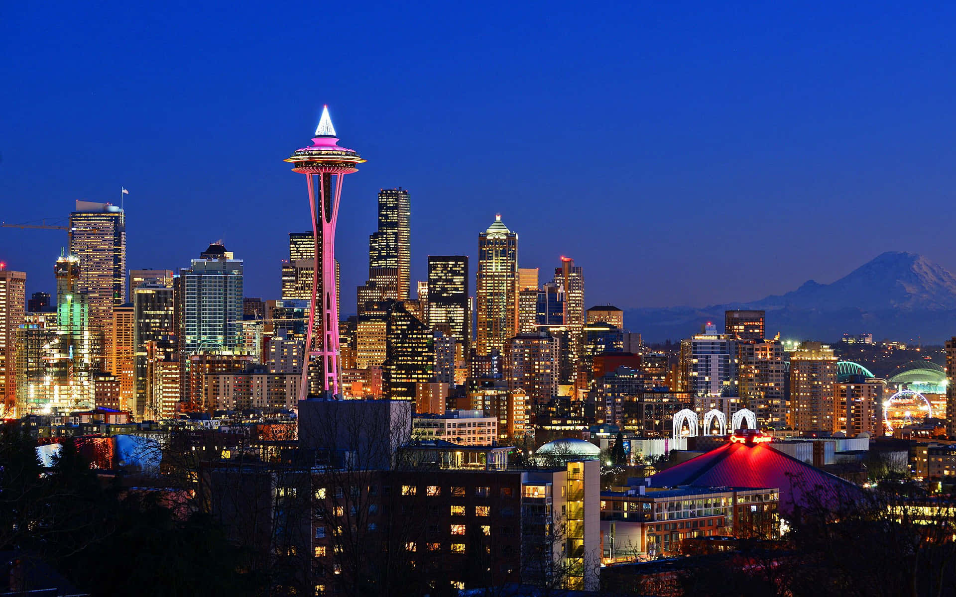 A City Skyline With A Mountain In The Background Background