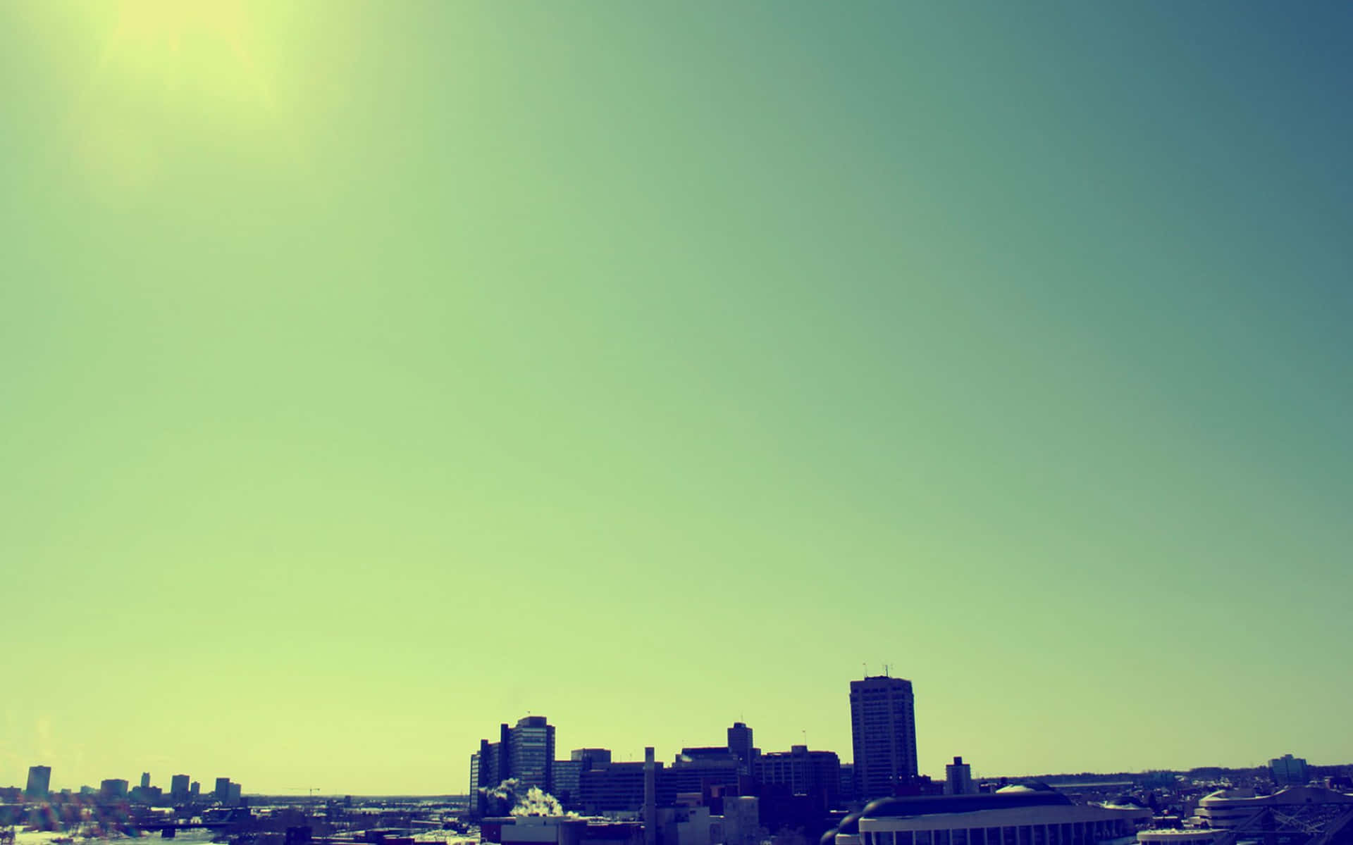 A City Skyline With A Plane Flying Over It