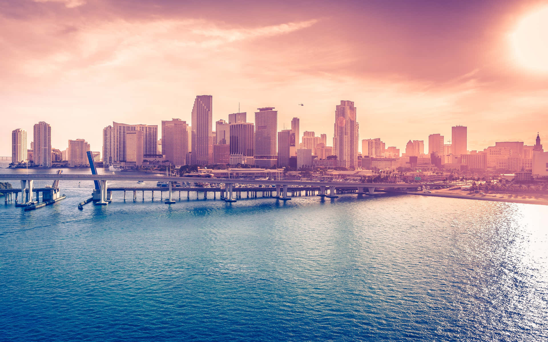 A City Skyline With Water And A Bridge