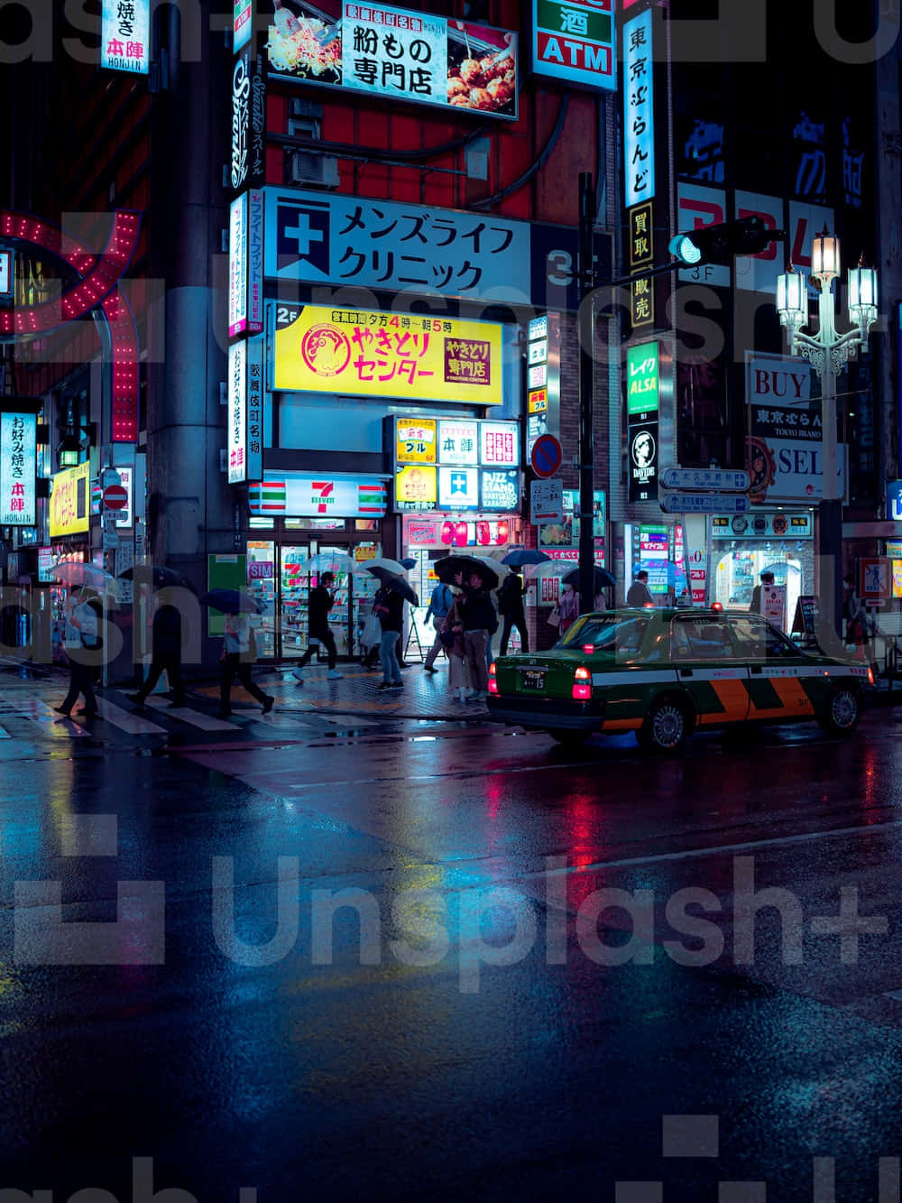 A City Street At Night With Many Signs Background