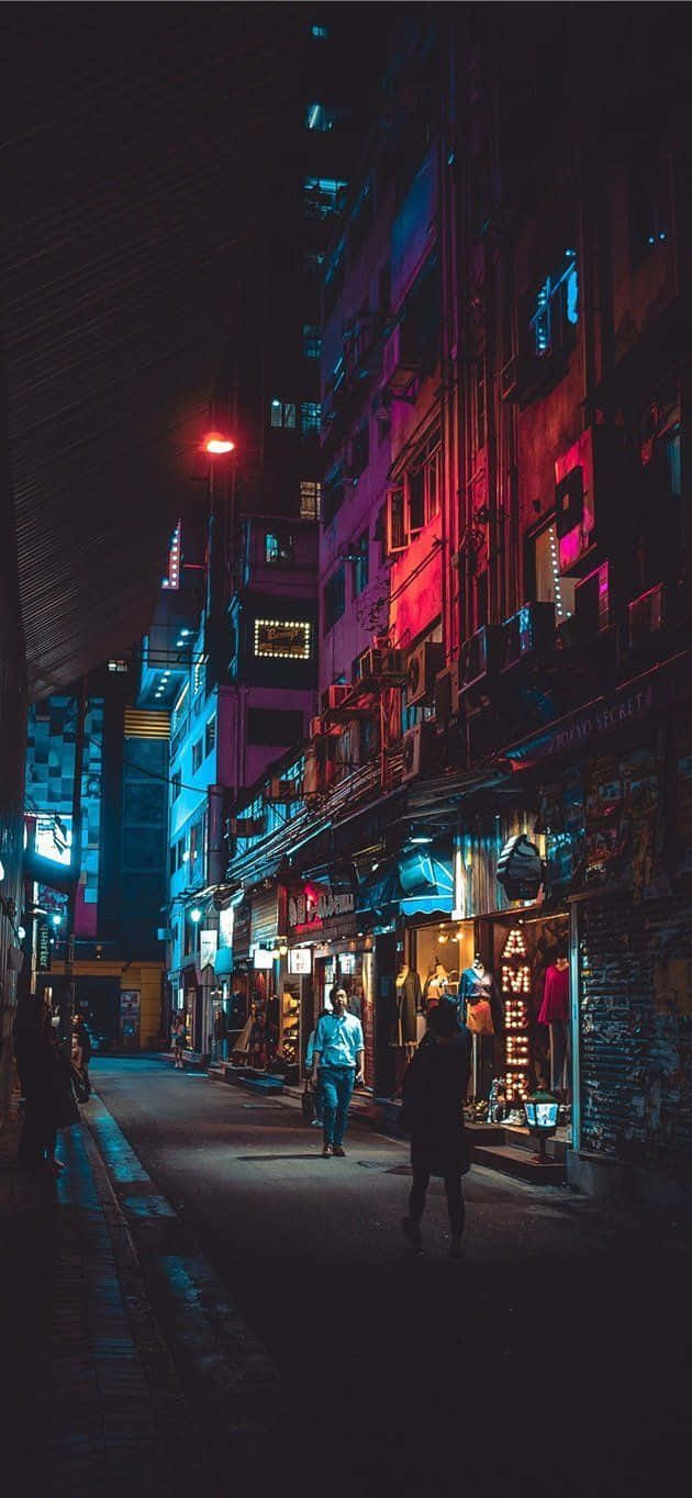 A City Street At Night With Neon Lights Background