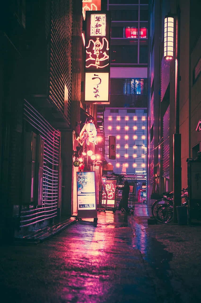 A City Street At Night With Neon Signs Background