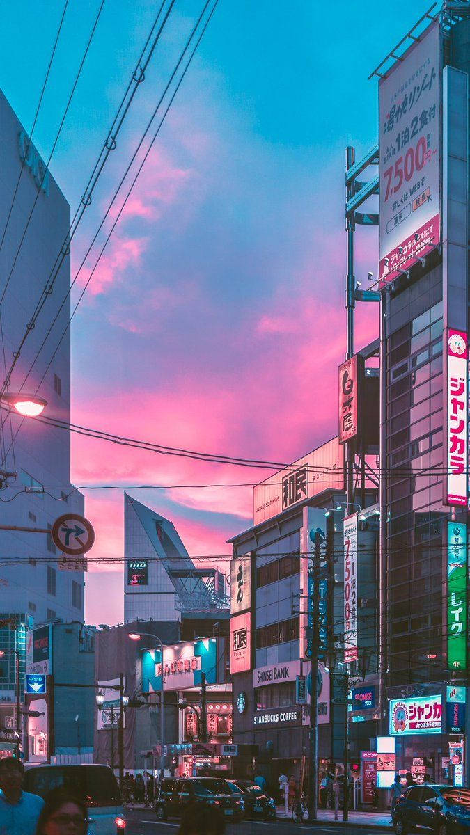 A City Street With A Pink Sky Background