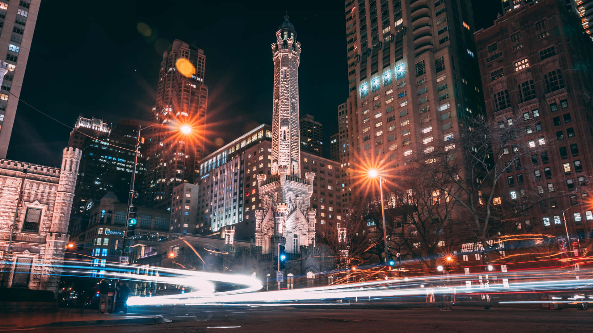 A City Street With Lights And Buildings At Night Background