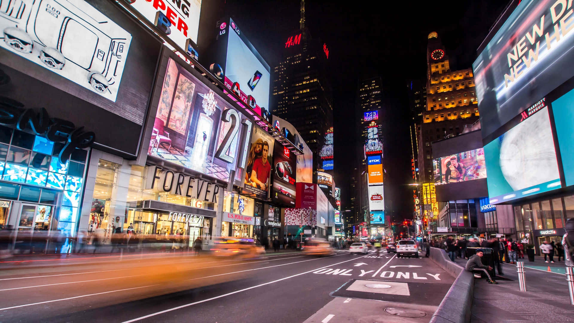 A City Street With Many Billboards And Signs
