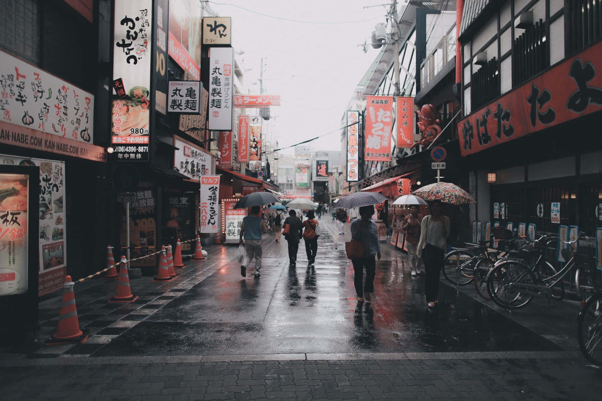 A City Street With People Walking With Umbrellas Background