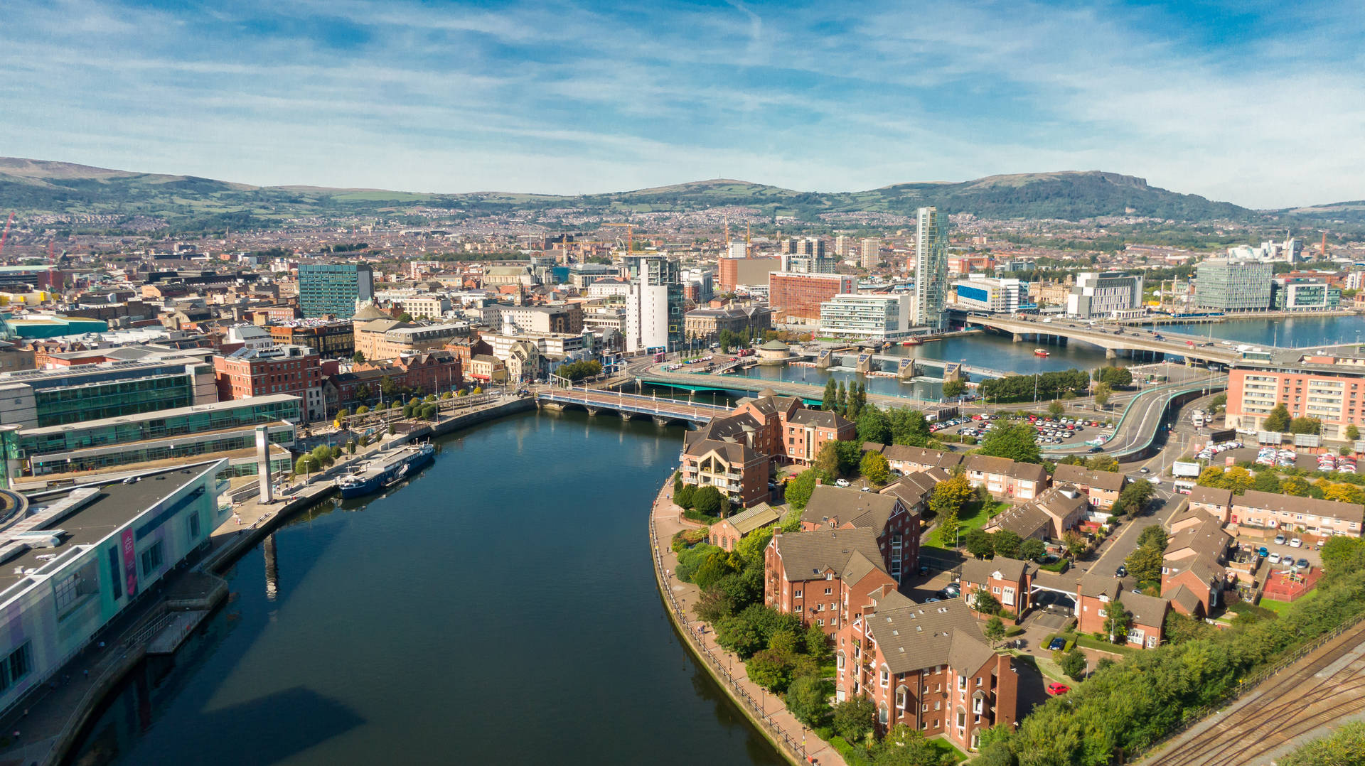 A City With A River And Buildings In The Background Background