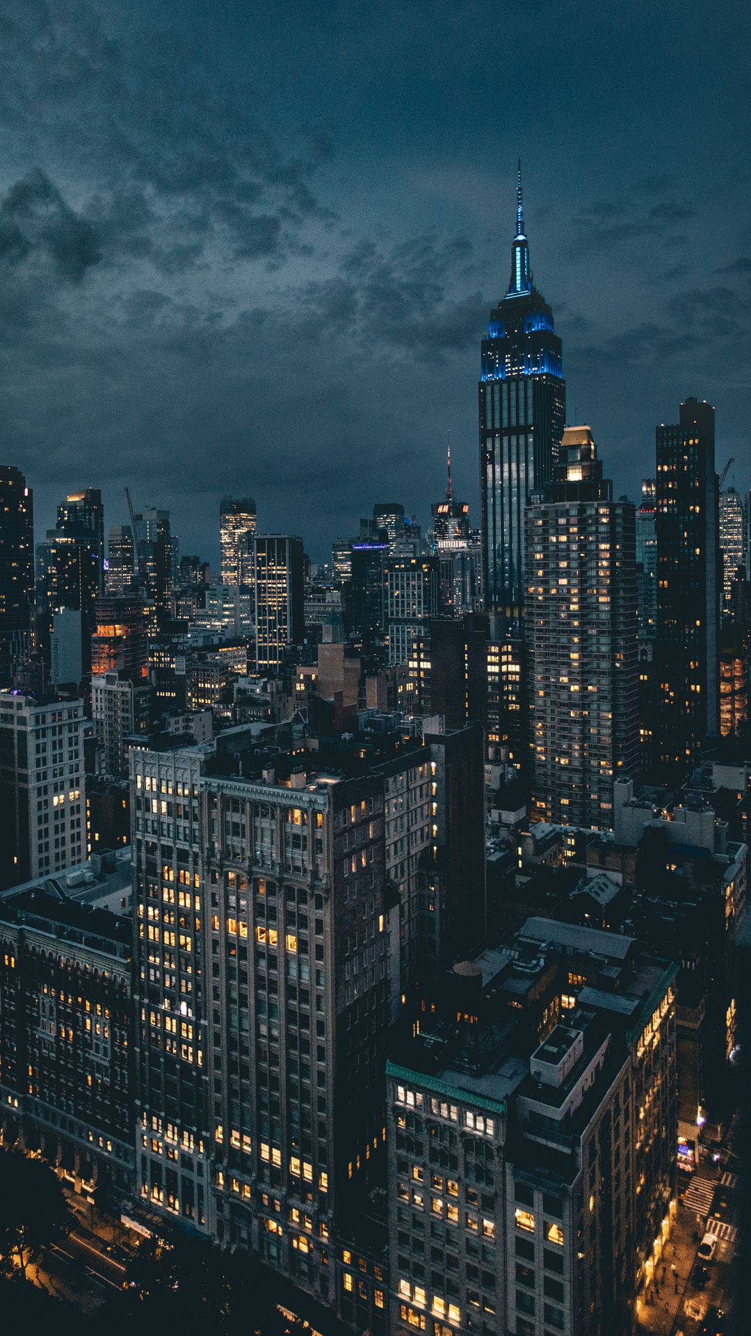 A Cityscape At Night With Buildings And Lights Background