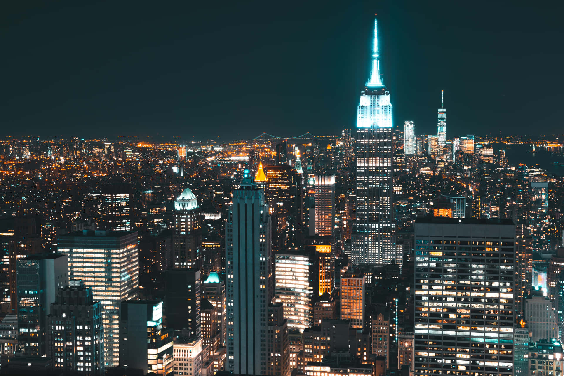 A Cityscape At Night With Lights On Background