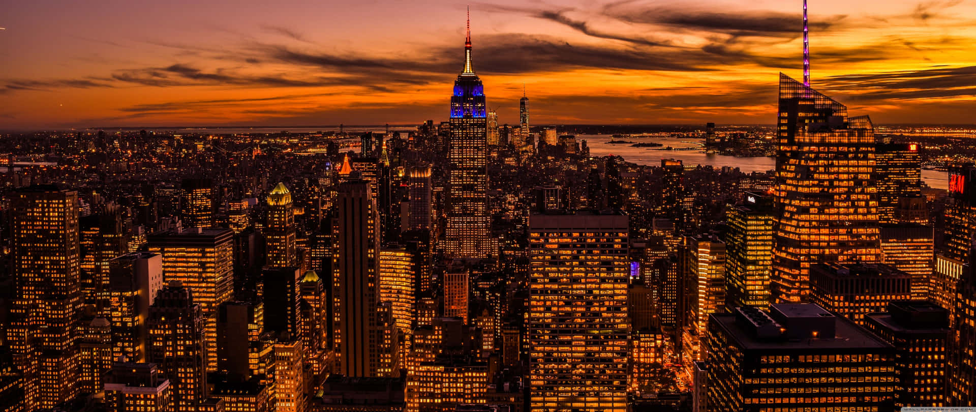 A Cityscape At Sunset With A City In The Background Background