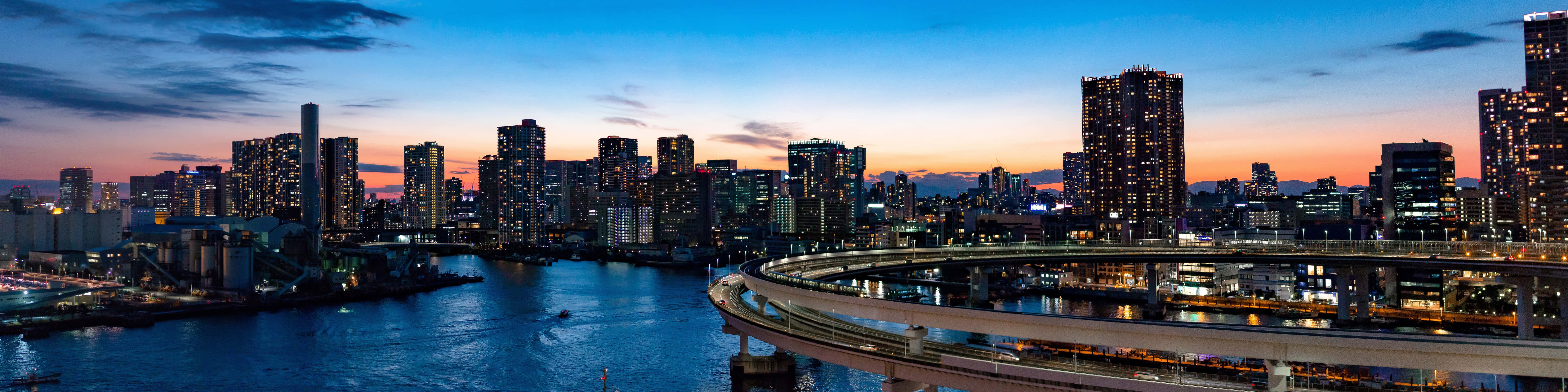 A Cityscape With Bridges And Buildings At Dusk Background