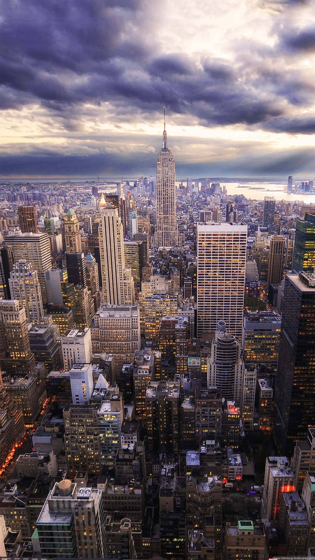 A Cityscape With Buildings And Clouds Background