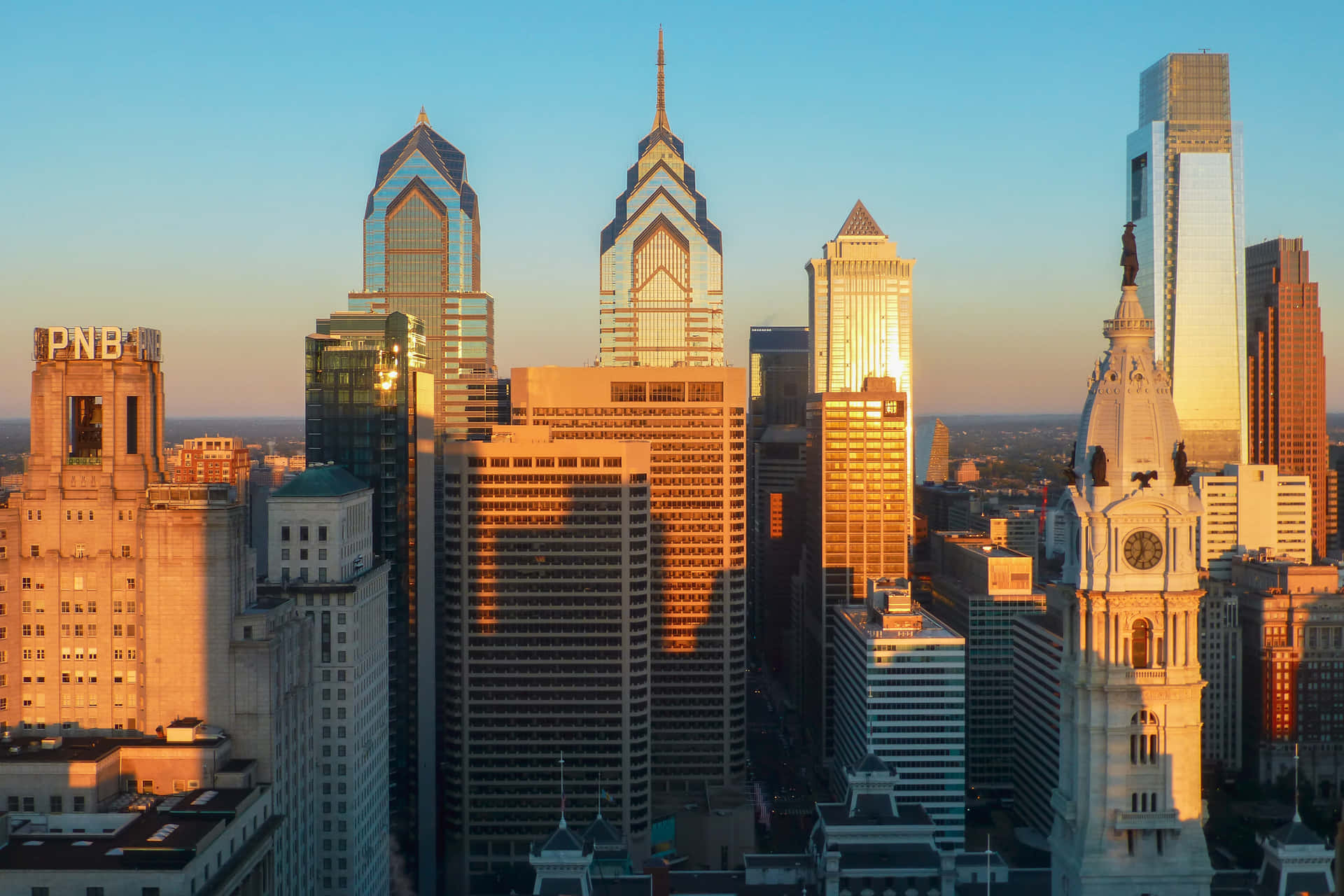 A Cityscape With Tall Buildings And A Clock Tower Background