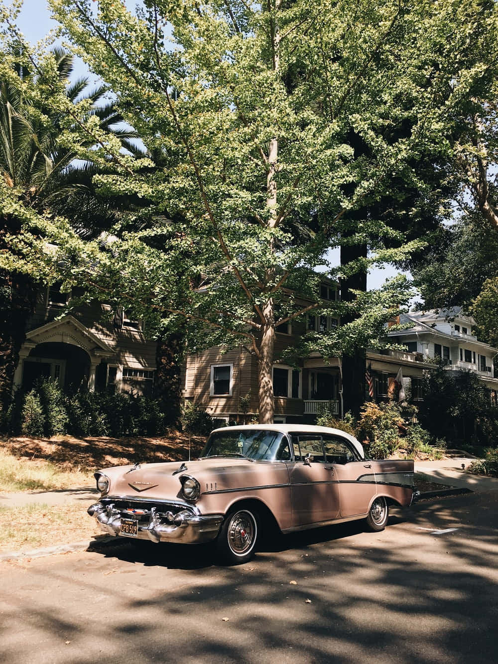 A Classic Car Parked In Front Of A House Background