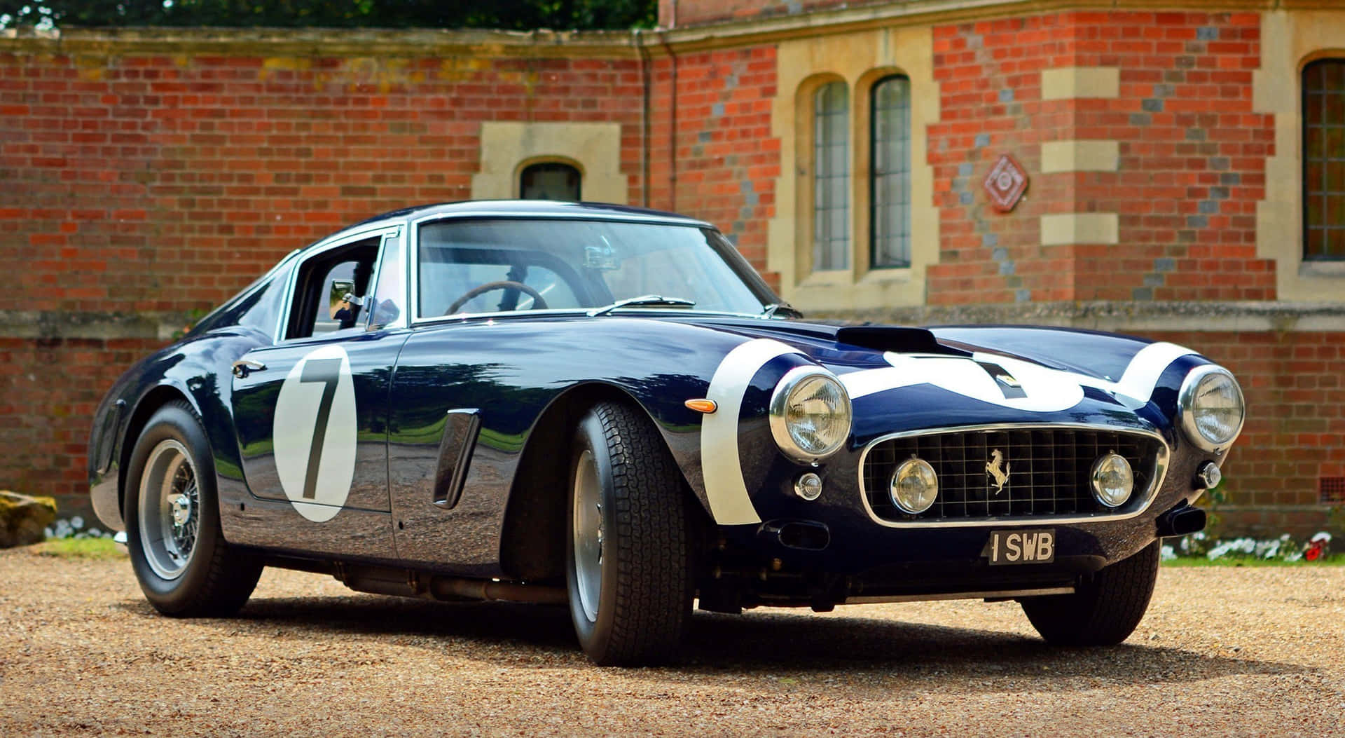 A Classic Ferrari Drives Through The Scenic Coastline Background