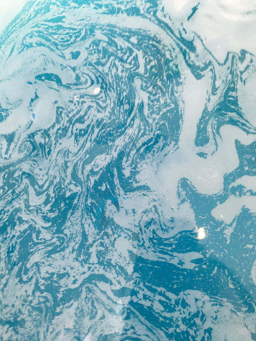 A Close Up Of A Blue And White Liquid Background